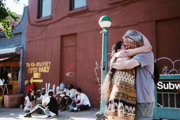 "New York is Back"? - Couple embracing outside of a beer hall. June 2020, Brooklyn.