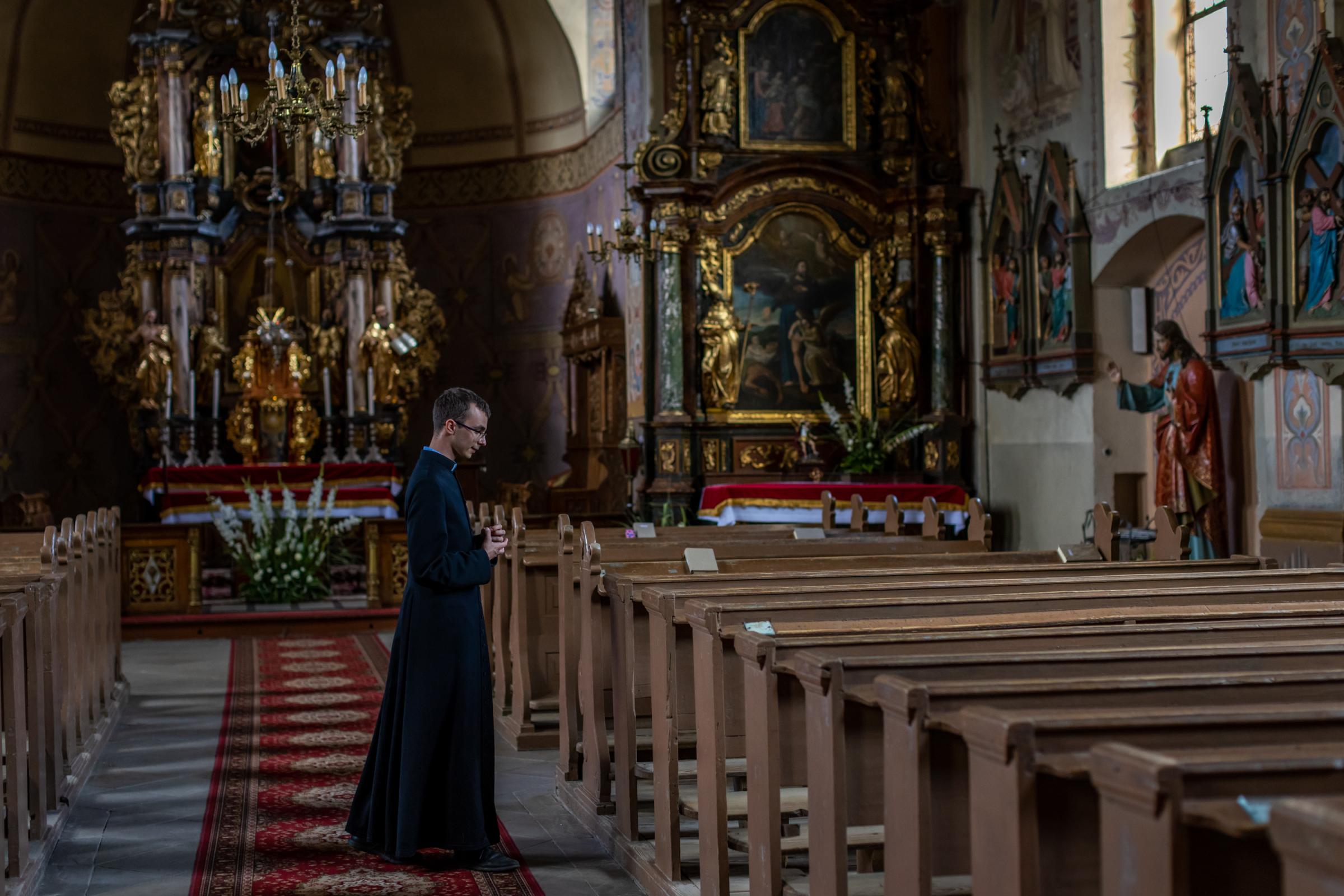 LONELY POLISH PRIEST -for NRC - Cleric Krzysztof Dzikowski in the church in Ramsowo