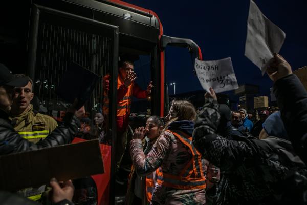 Image from OVER THE BORDER - 02/26/2022 Przemysl, Poland. A volunteer asks people in...