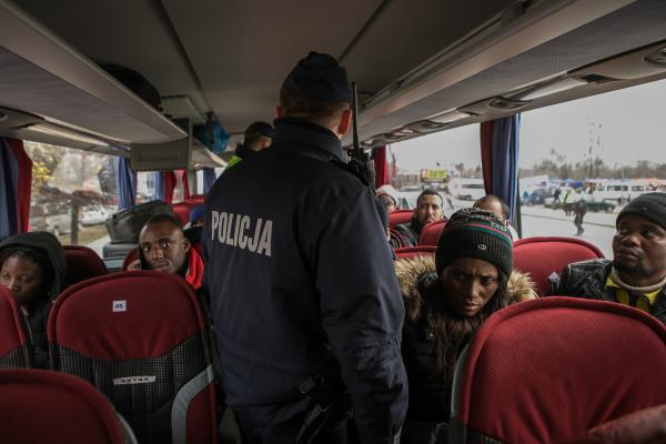 Image from OVER THE BORDER - Police board a bus of foreigners who recently arrived in...