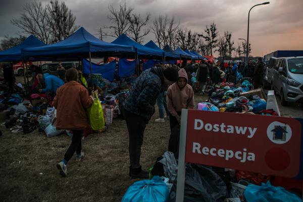 Image from OVER THE BORDER - People donating clothing and food at a makeshift refugee...