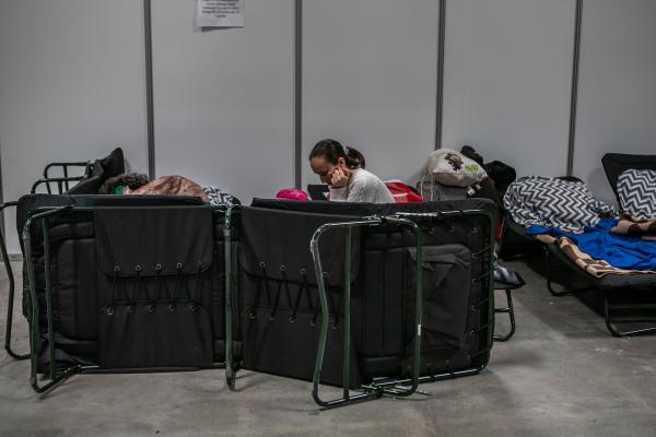 Image from OVER THE BORDER - The Expo Hall is one of the largest shelters for refugees...