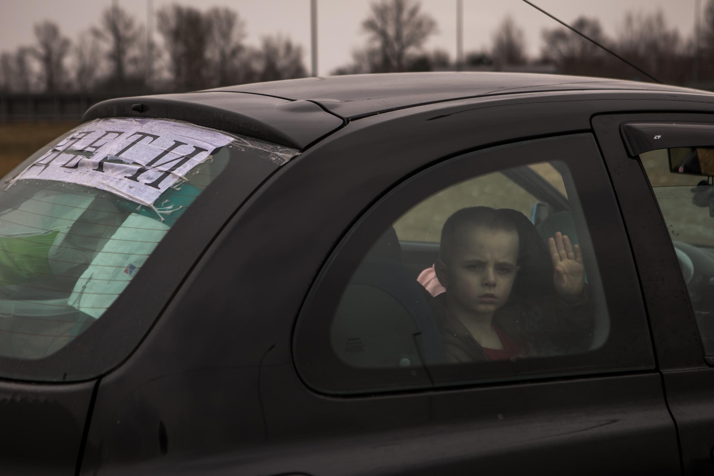  A sign that says &ldquo;children&rdquo; in Ukrainian on the back of a car driven by Tanya Salo. She left the family&rsquo;s home in Kharkiv, Ukraine and drove for five days to the Polish border with her husband, three children &ndash; Fedir, 4 ( in the picture ), Mykhailo, 8, Kamila, 12 - and pet dog, Ozipa, and cat, Sarah. She had to say goodbye to her husband at the border and carry on to Gdańsk, Poland. 9.03.2022 Rest stop Budy Łańcuckie, Poland. ( On assignment for The Globe and Mail ) 