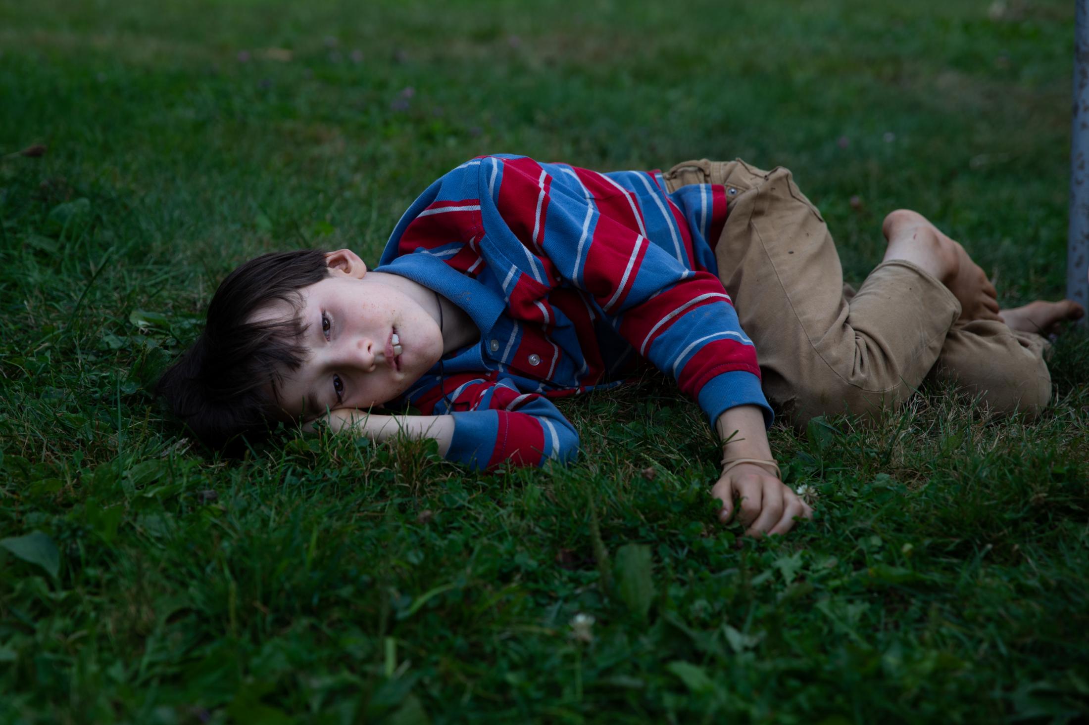 Noa lays on the grass Bremen, Maine, 2020.