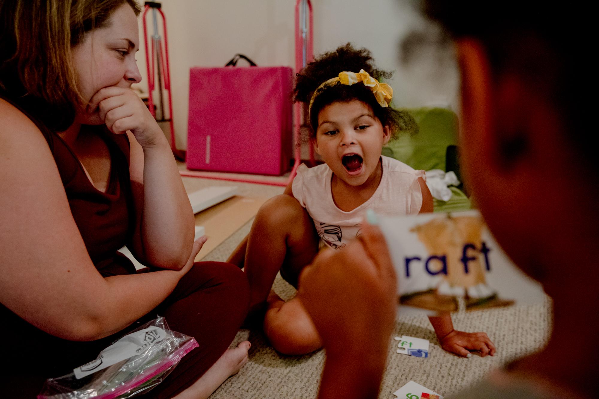 Juliet spells out a word that her sister Anya reads. Making sure her daughters continued to learn at home was Tracey&rsquo;s main concern, especially because Juliet was going to enter kindergarten later in 2020.