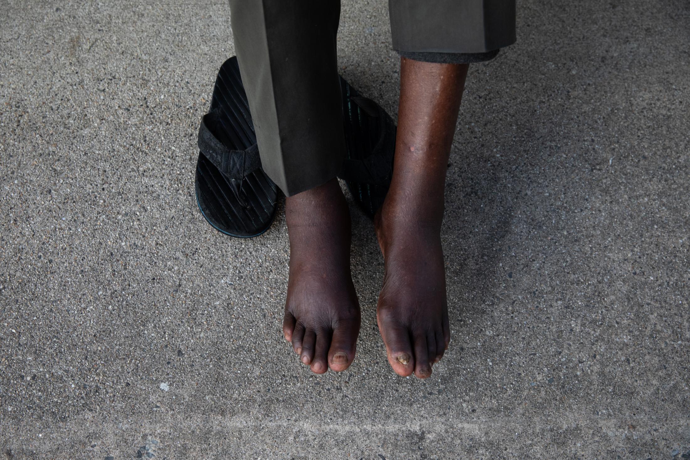Belonging - A Sudanese man sits outside his home in Portland Maine,...