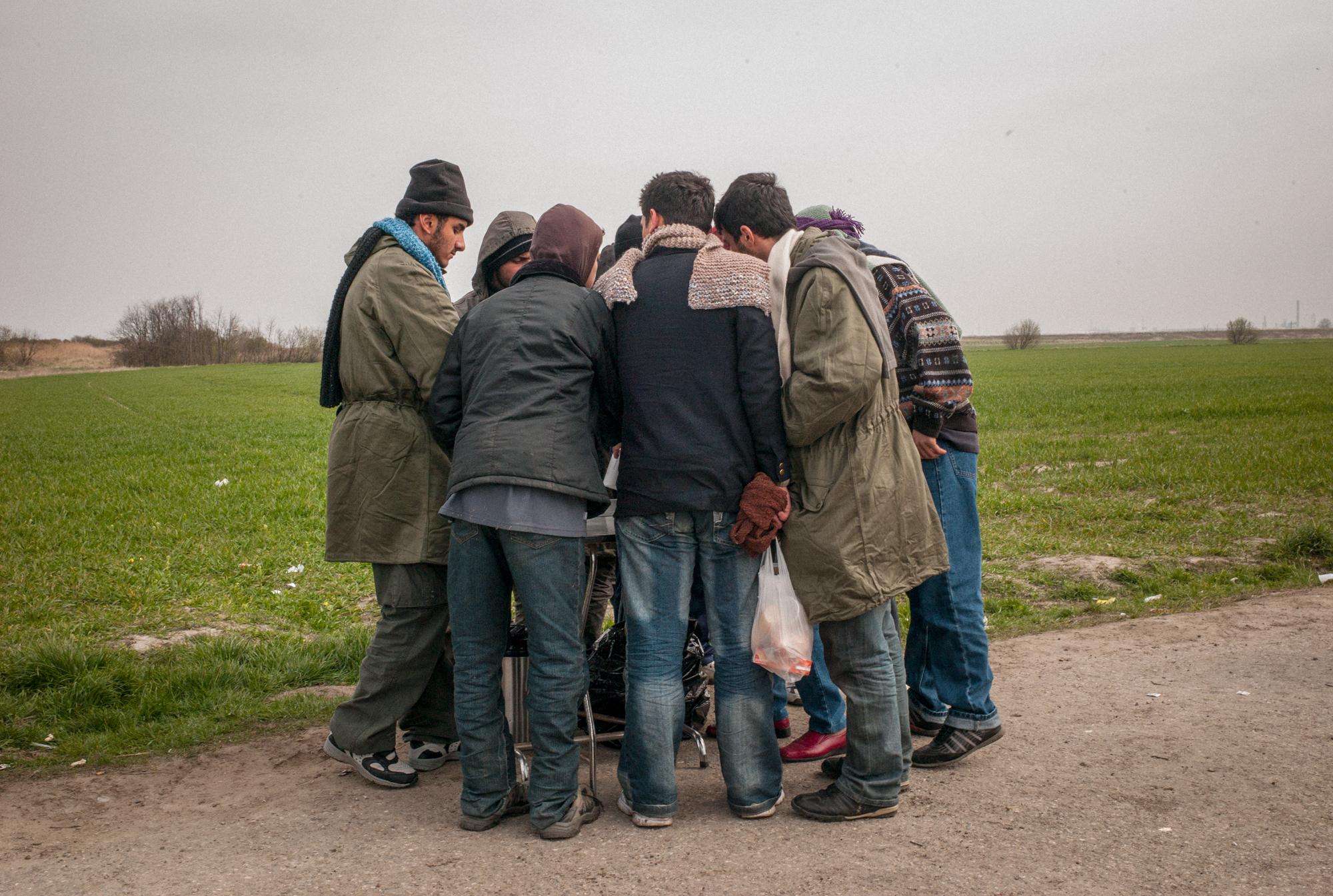 Migrants in Calais, France (2008) - Kurdish and Afghan immigrants gather to receive clothing...