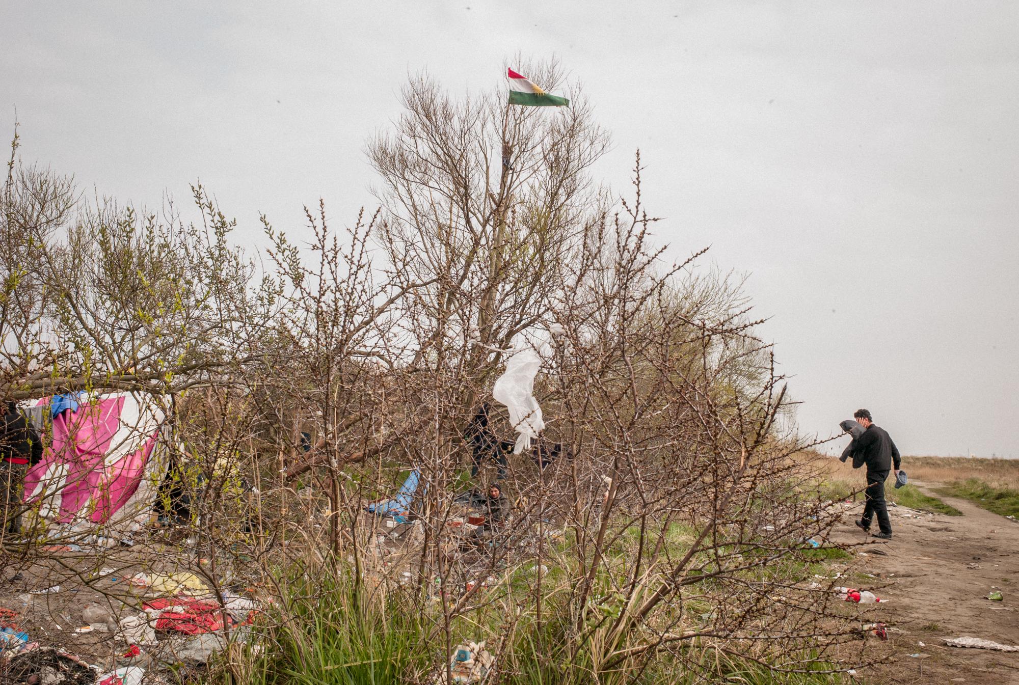 Migrants in Calais, France (2008) - Kurdish immigrants raise Kurdish flag over camp, while...