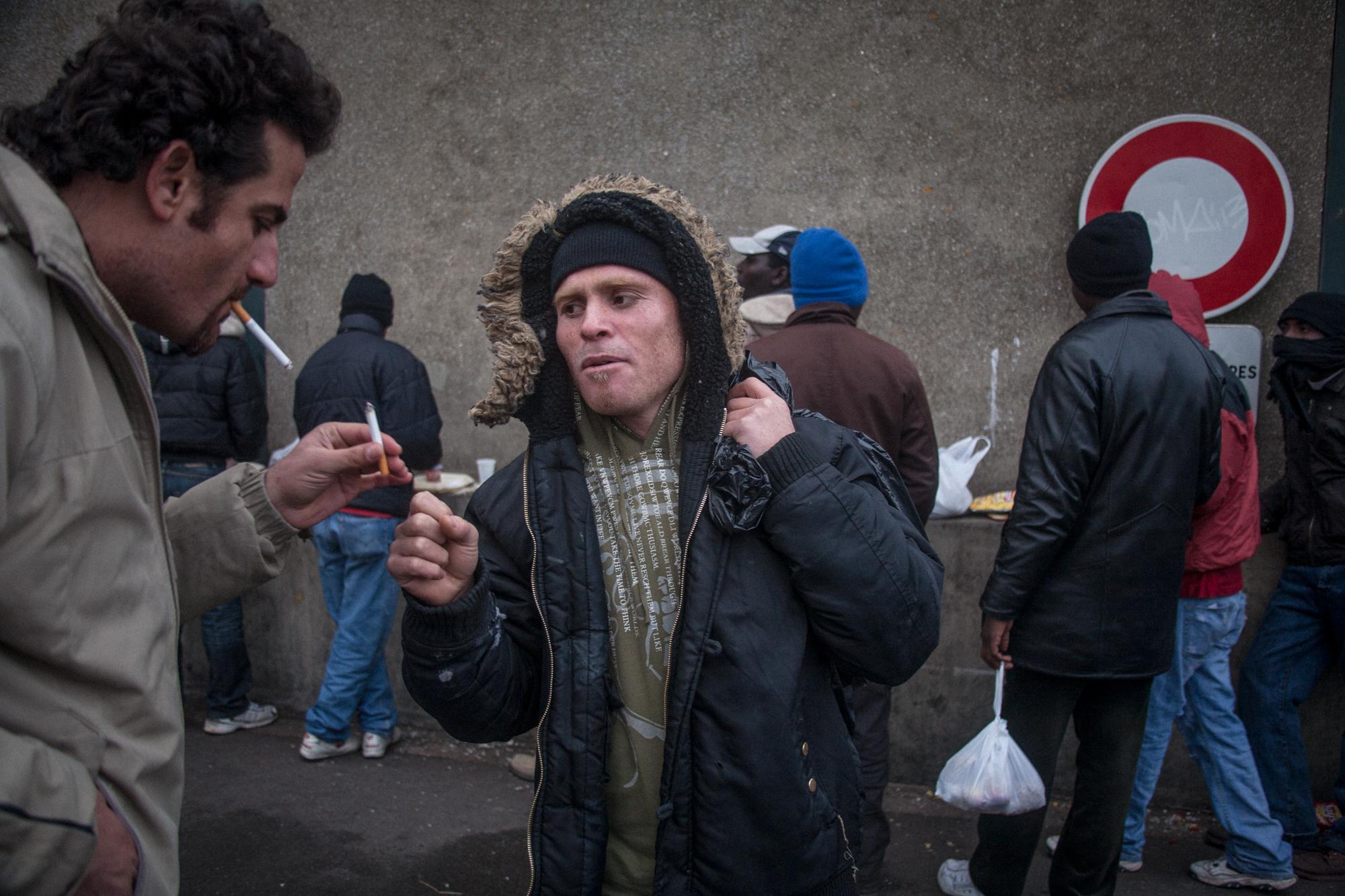 Migrants in Calais, France (2008) - Kurdish immigrant after daily evening meal given by the...