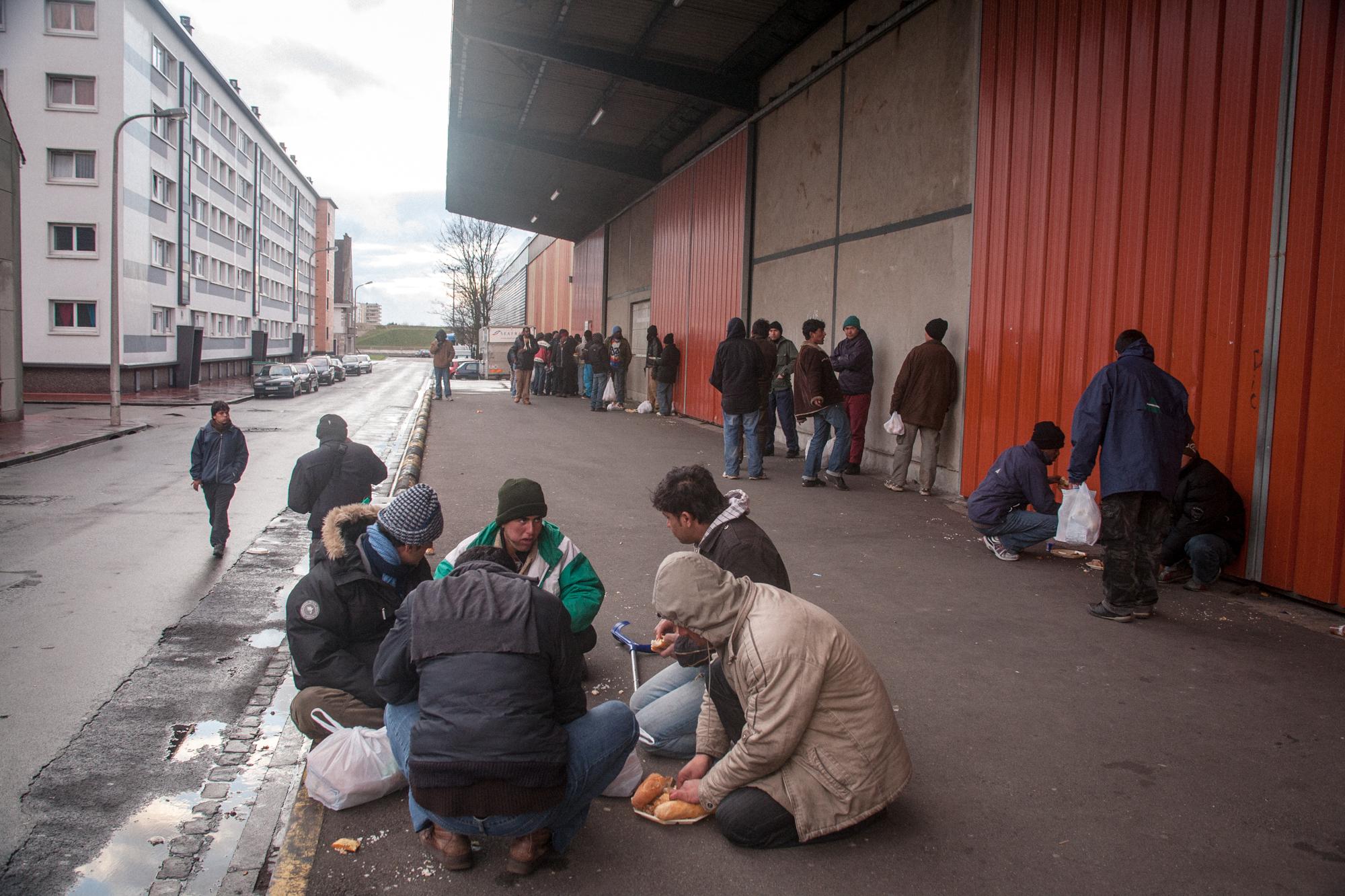 Afghan and Kurdish immigrants after daily evening meal given by the Association Salam. Calais,...