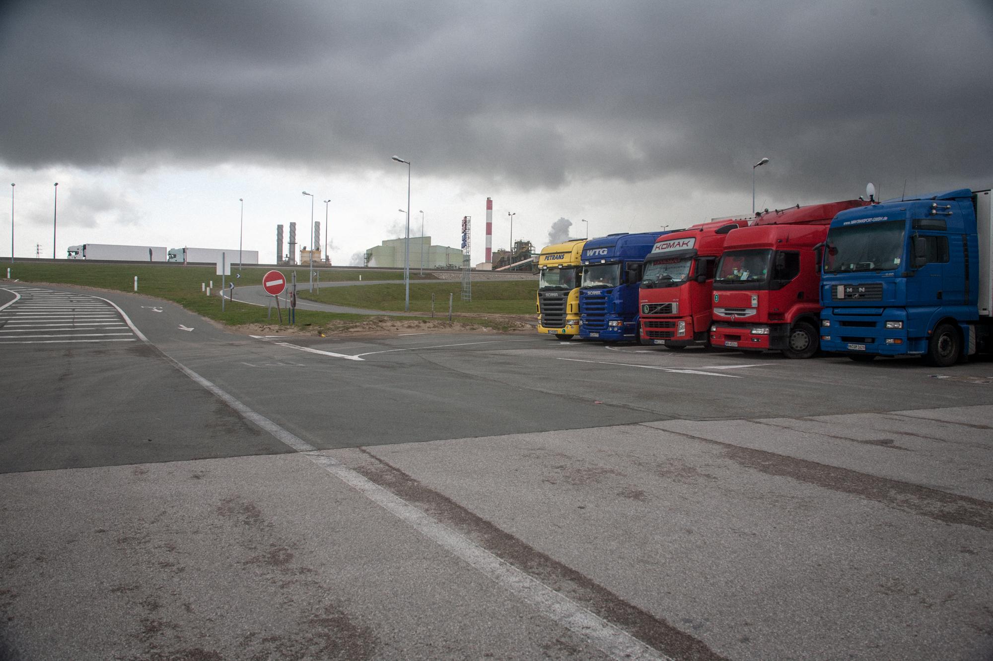 Trucks parked just opposite &quot;The Jungle&quot; waiting to cross the Channel. Calais,...