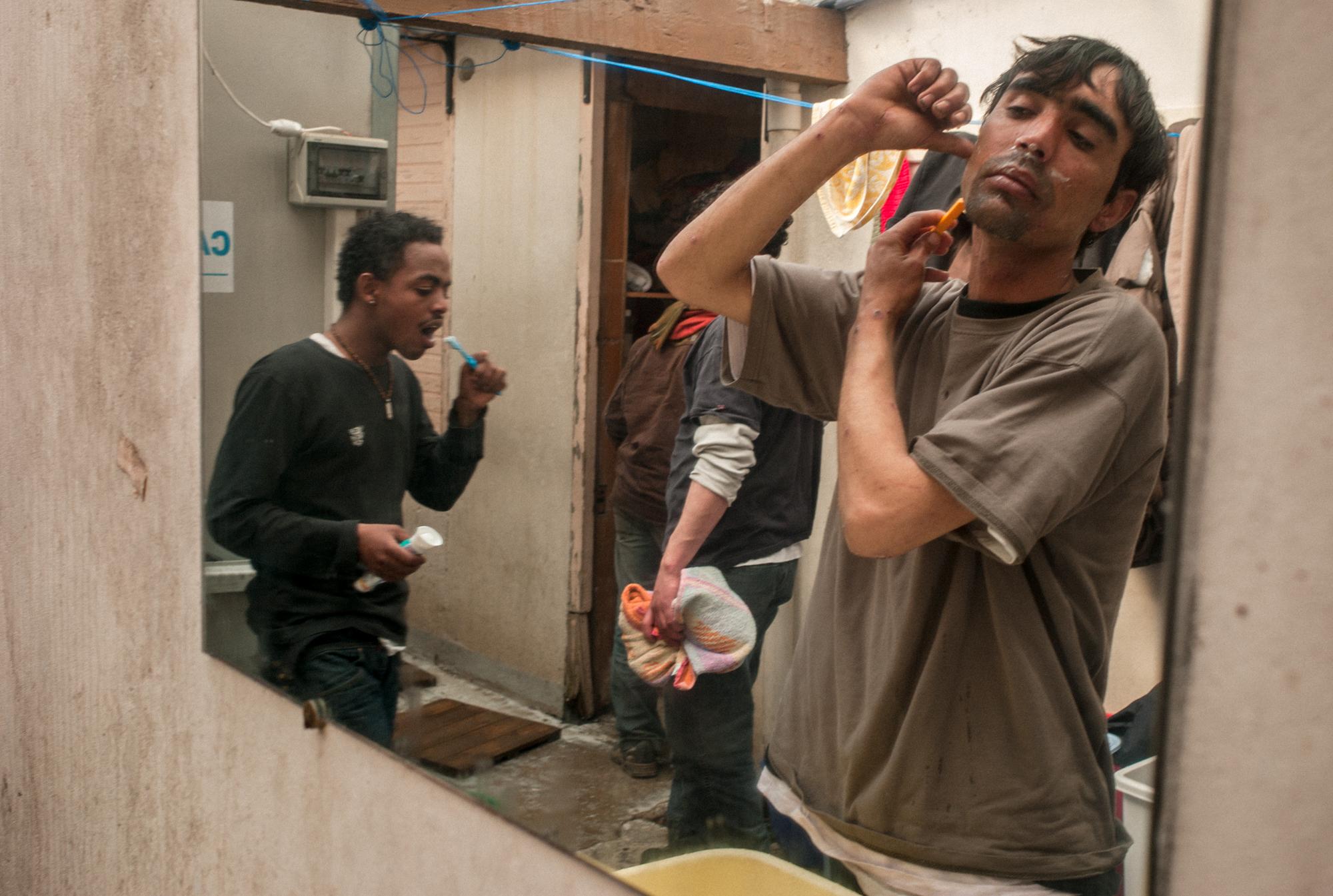 Iranian and Eritrean immigrants at Secours Catholiques which provides daily shower facilities....
