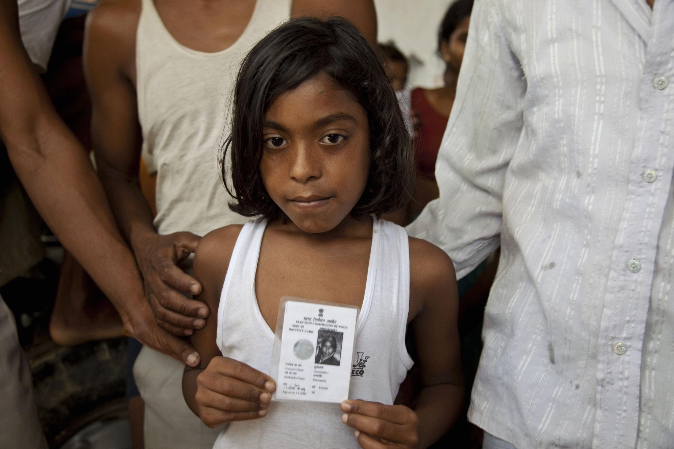 Maternal Mortality, India (2009) - Komal, holding ID of her mother, Kiran Yadav, who died...