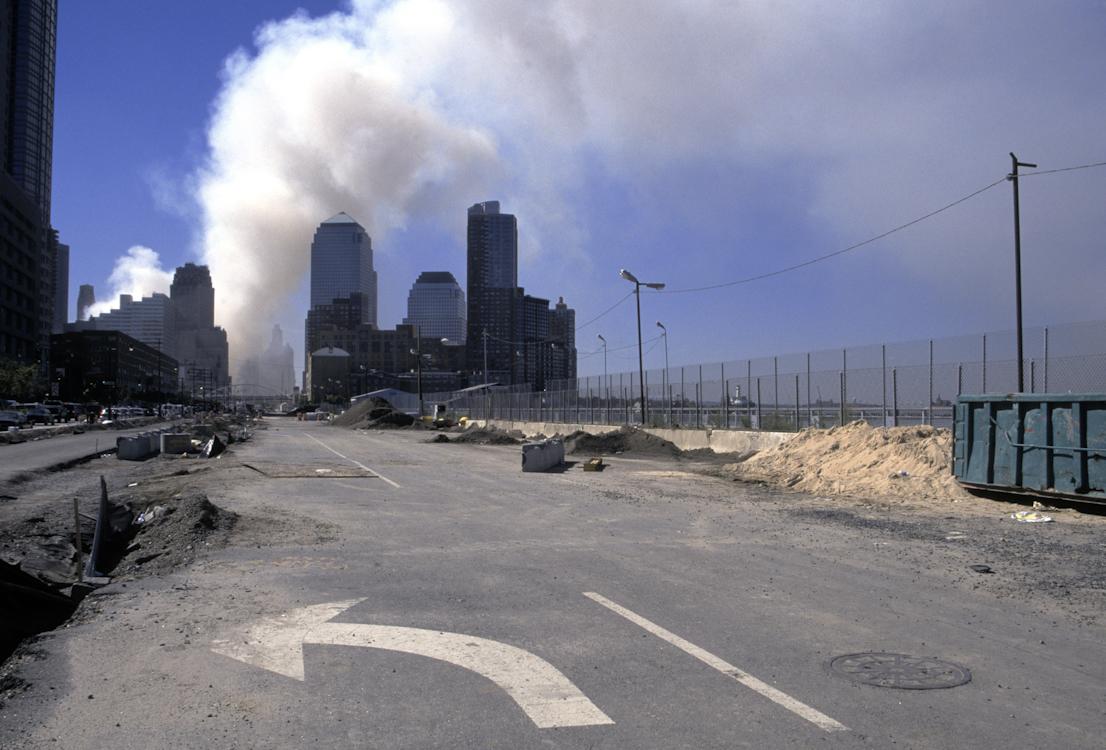 Smoke rises above the World Financial Center after the collapse of the World Trade...