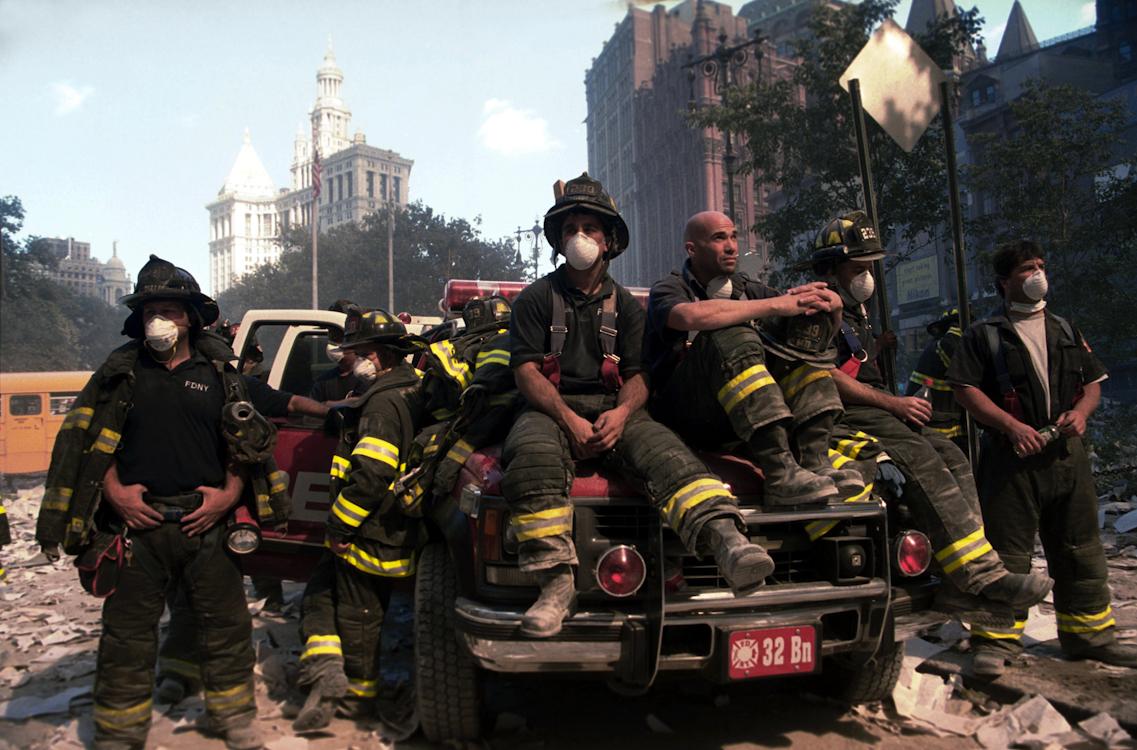 Terrorist attack on World Trade Center. Near City Hall. Firefighters recuperate from having gone...