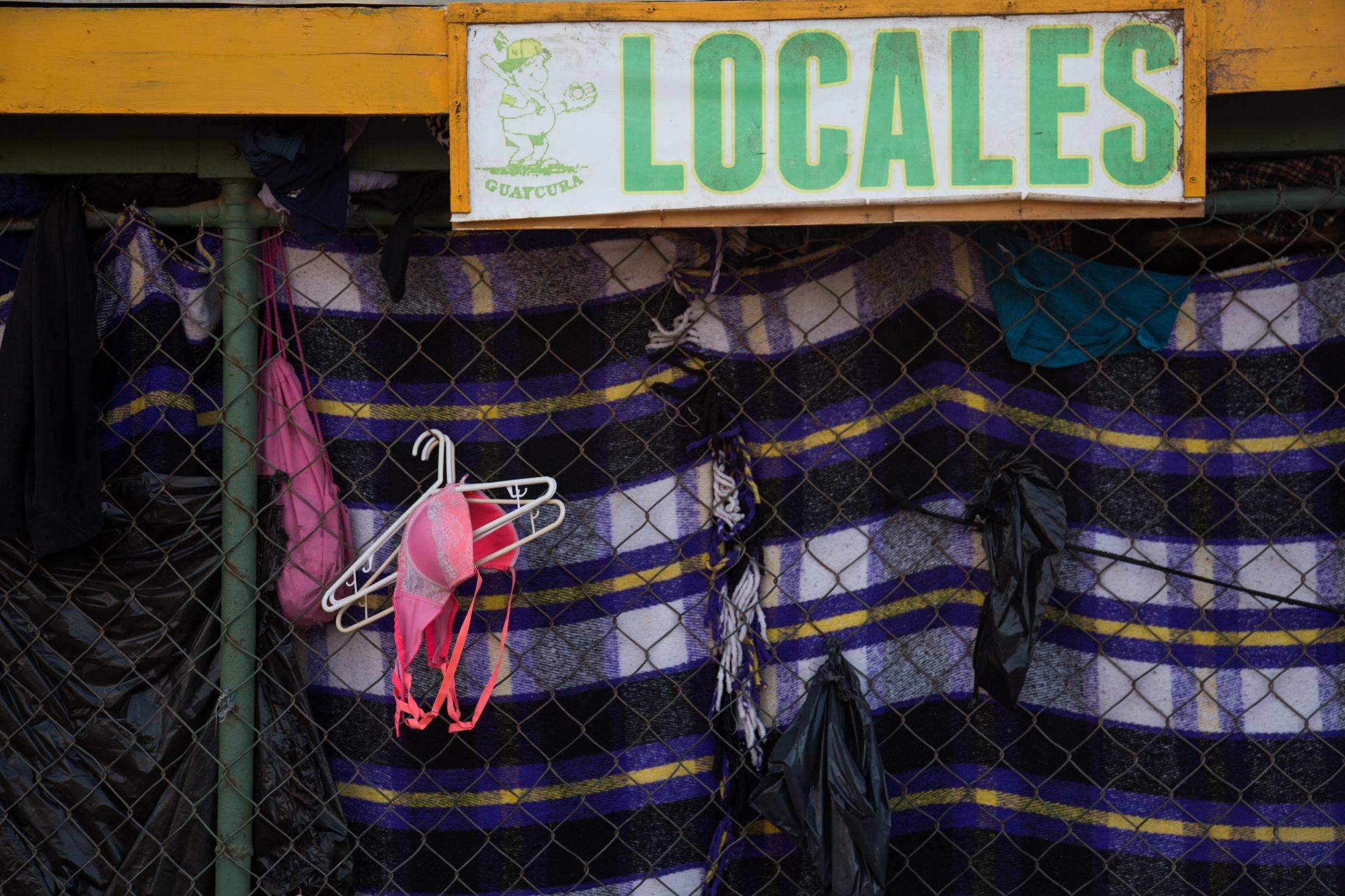United States/Mexico Border Revisit - Clothing hanging in the Benito Juarez shelter. Tijuana,...