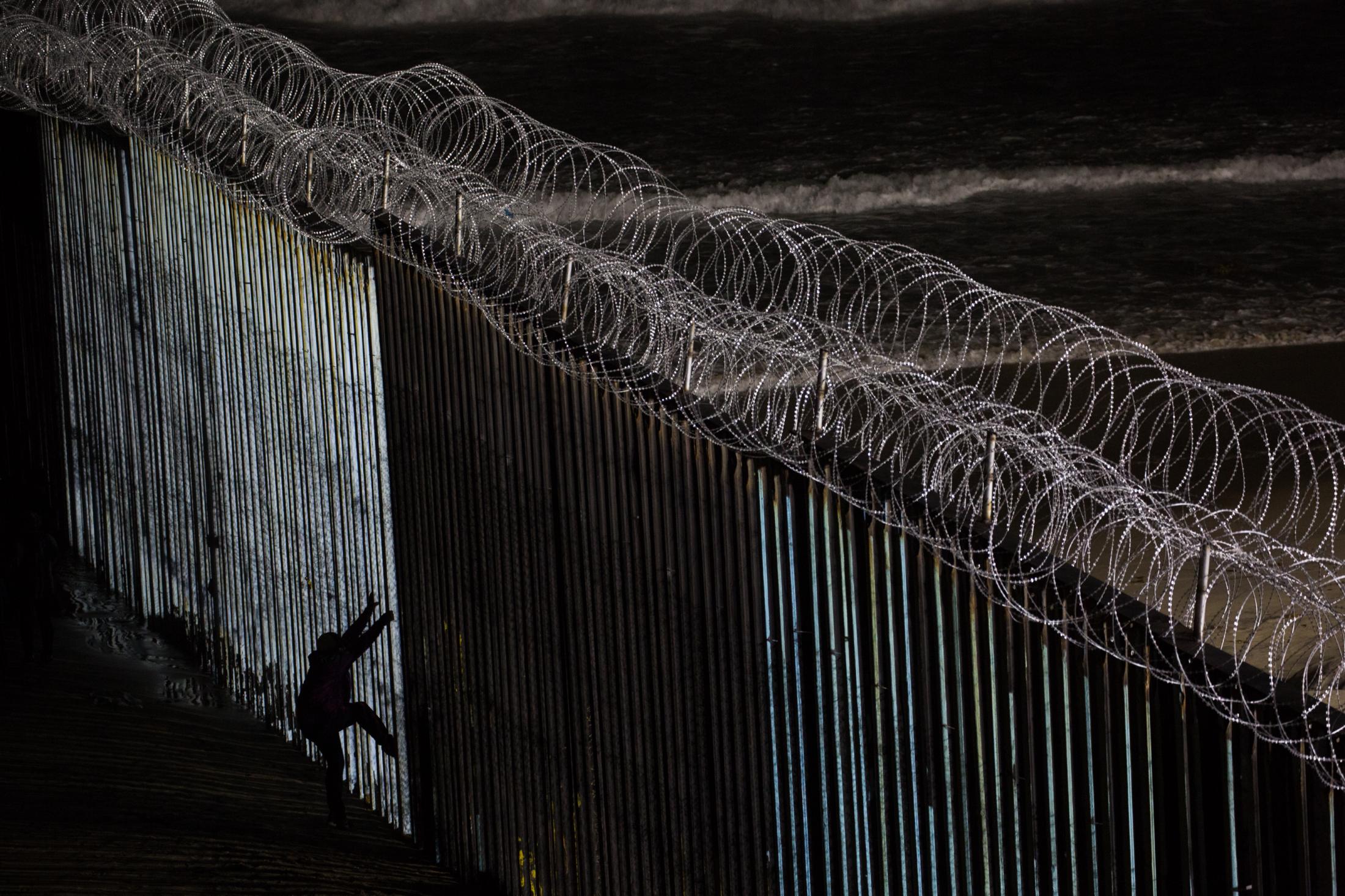 Migrants trying to jump the US-Mexico wall at Tijuana beach. Tijuana, Mexico.&nbsp;