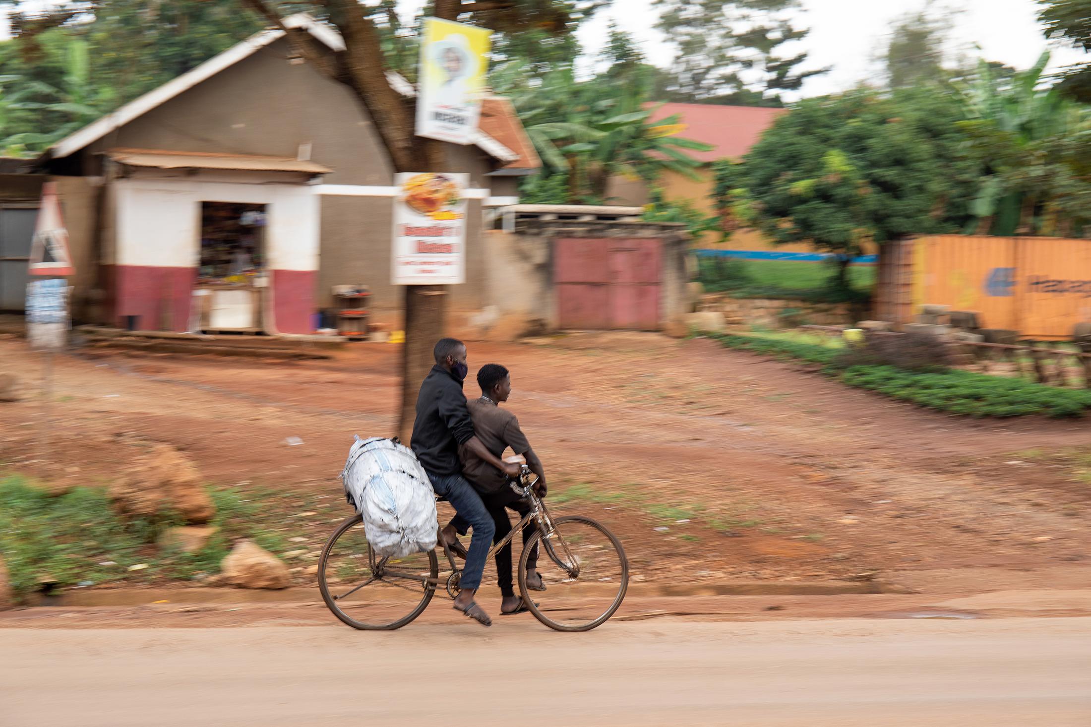 Domestic Express - Young men who sell charcoal deliver a charcoal sack to their client.