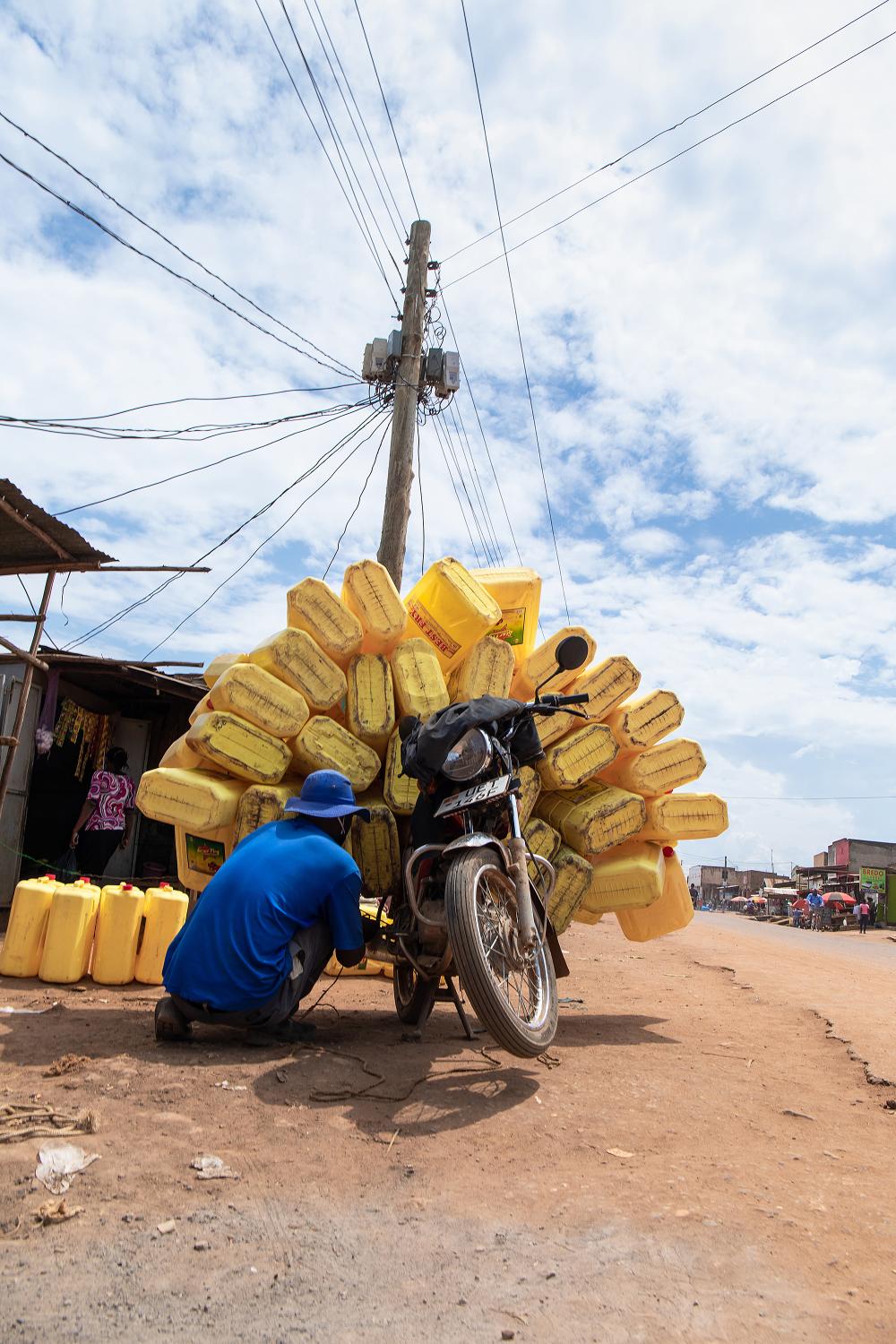 Domestic Express - A bodaboda rider in Mukono town, ties his cargo onto his motorbike. Transport of passengers was...