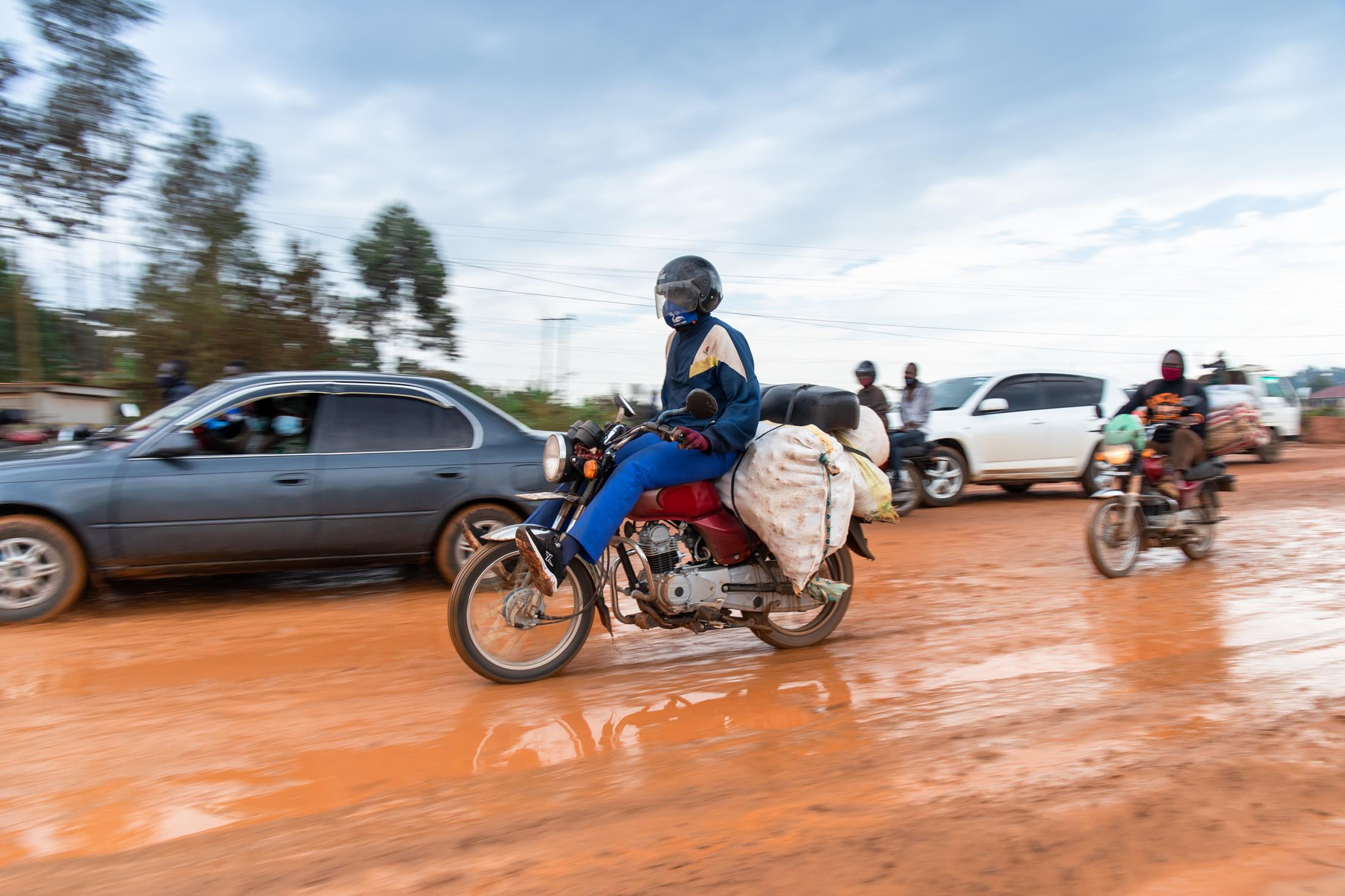 Domestic Express - A rider speeds through a muddy stretch after a downpour, this was in Mukono district which is...