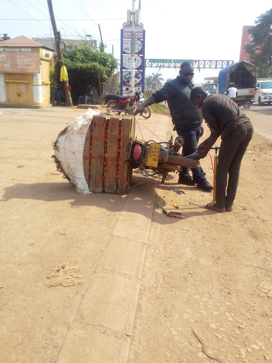 Domestic Express - A flat tyre is something one can&#39;t avoid, here a rider delivering tomatoes gets his tyre...