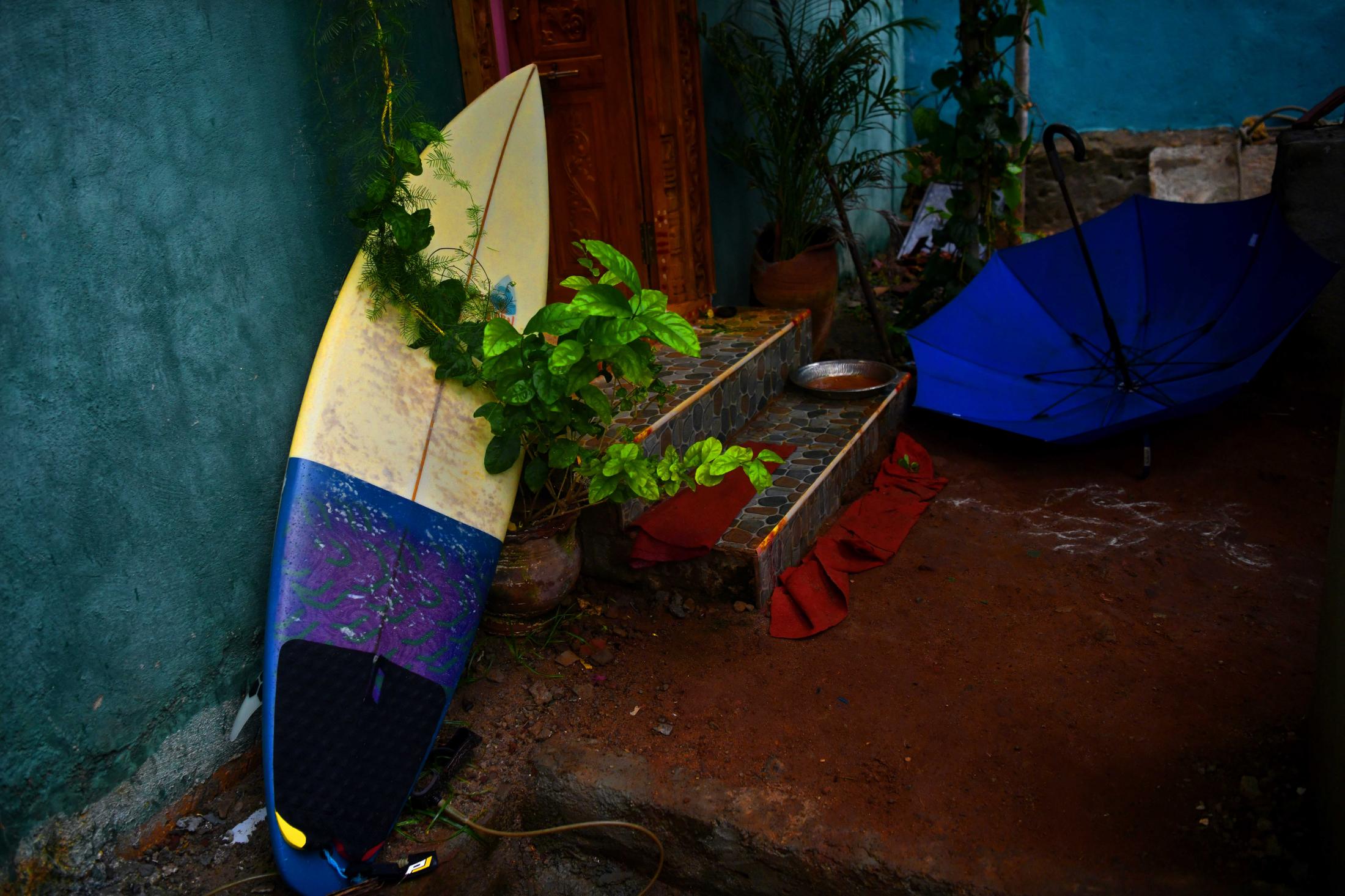 A very common sight in fisherman&rsquo;s colony. Surf boards are found outside homes of surfers. The first-generation surfers along the coast of Tamil Nadu are Mukesh Panjanathan known as Mumu, Velu, Santosh, Murthy and Shankar who learnt surfing by watching foreigners and passed on the knowledge to the younger generations. While they wanted to surf, they had no access to equipment. Mumu said &ndash; &ldquo;All the children who surf here are from fishing communities and the sea is their playground&rdquo;. All of them accompany their parents in the morning to fish in wooden boats and when the boat is pulled apart to dry, Mumu along with his friends took a plank and skid into the sea on their belly&rsquo;s. These planks are similar to boogie (body) boards. Mumu (36) dropped out of school and did odd jobs such as working in restaurants, cleaning homes, toilets and more. He hated his life and decided to pursue surfing seriously but no one gave him a board. He said &ndash; &ldquo;I approached foreigners who came here to surf and most of them said no. It&rsquo;s only after I got my first board did, I realise why. They are not only expensive but delicate. If anything happened to a board fixing it would be an impossible task as you did not get raw materials in India then.&rdquo; Two foreigners left their boards behind and one of his friends who took them used to give them on hire. However, it wasn&rsquo;t easy to afford one and he used to buy him a drink in return. A Japanese surfer wanted to sell his board before leaving and when Mumu asked him for it, he said &ndash; &ldquo;I am not giving it away, I am selling it.&rdquo; He managed to gather Rs.1,500 by borrowing from friends and family and told the Japanese surfer that this is all he has. The surfer then laughed and said &ndash; &ldquo;A leash costs that much but I will give this board to you for this price. I wanted you to earn the board and understand the value of it.&rdquo;