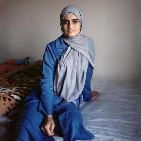 Image from In the Name of God -   Samira, 18, posing in her new home. Her mother, Ploshe,...