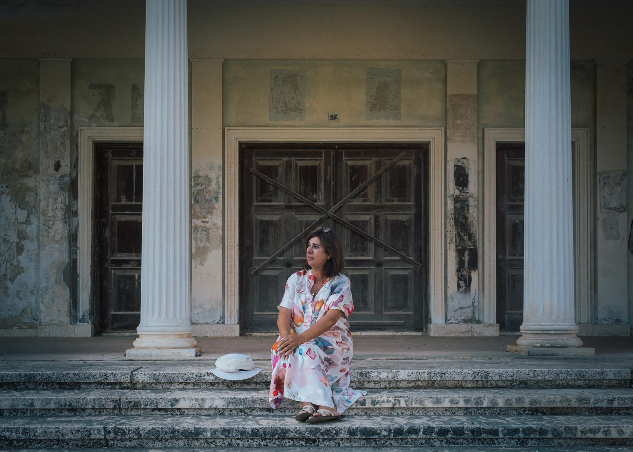 Tasoula Hadjitofi in front of her former culture school, where she learned to dance and sing.