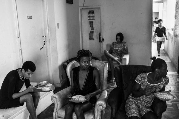 Rio's trans sex workers during COVID - Trans women residents of Casa Nem have lunch at the TV room.
