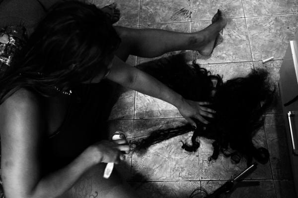 Rio's trans sex workers during COVID - Stefany Gon&ccedil;alves combs her wig at her house in downtown Rio de Janeiro.