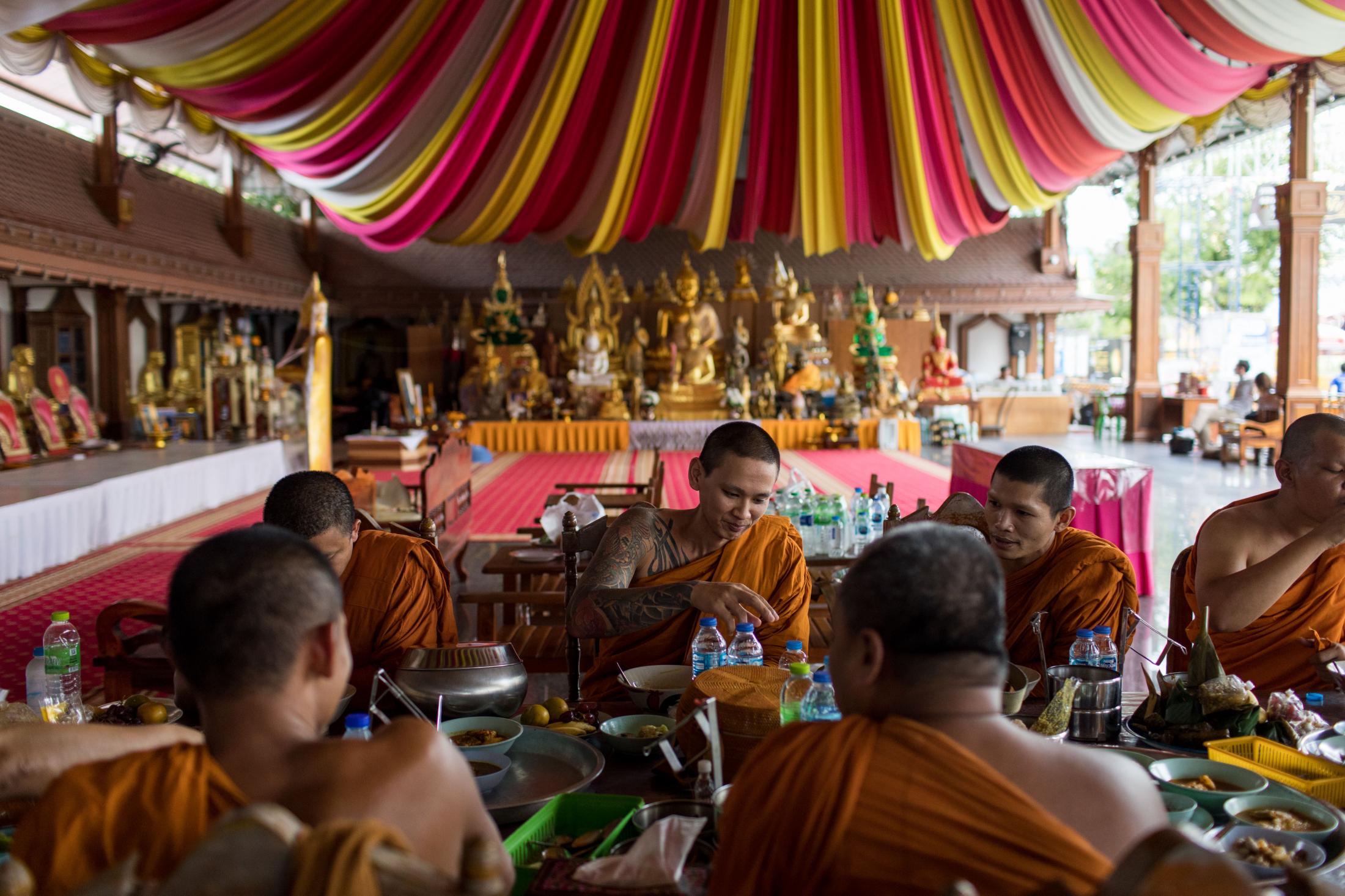 The monks of Wat Chedi Ai Khai eat lunch together on the temple grounds. At Wat Chedi Ai Khai in...