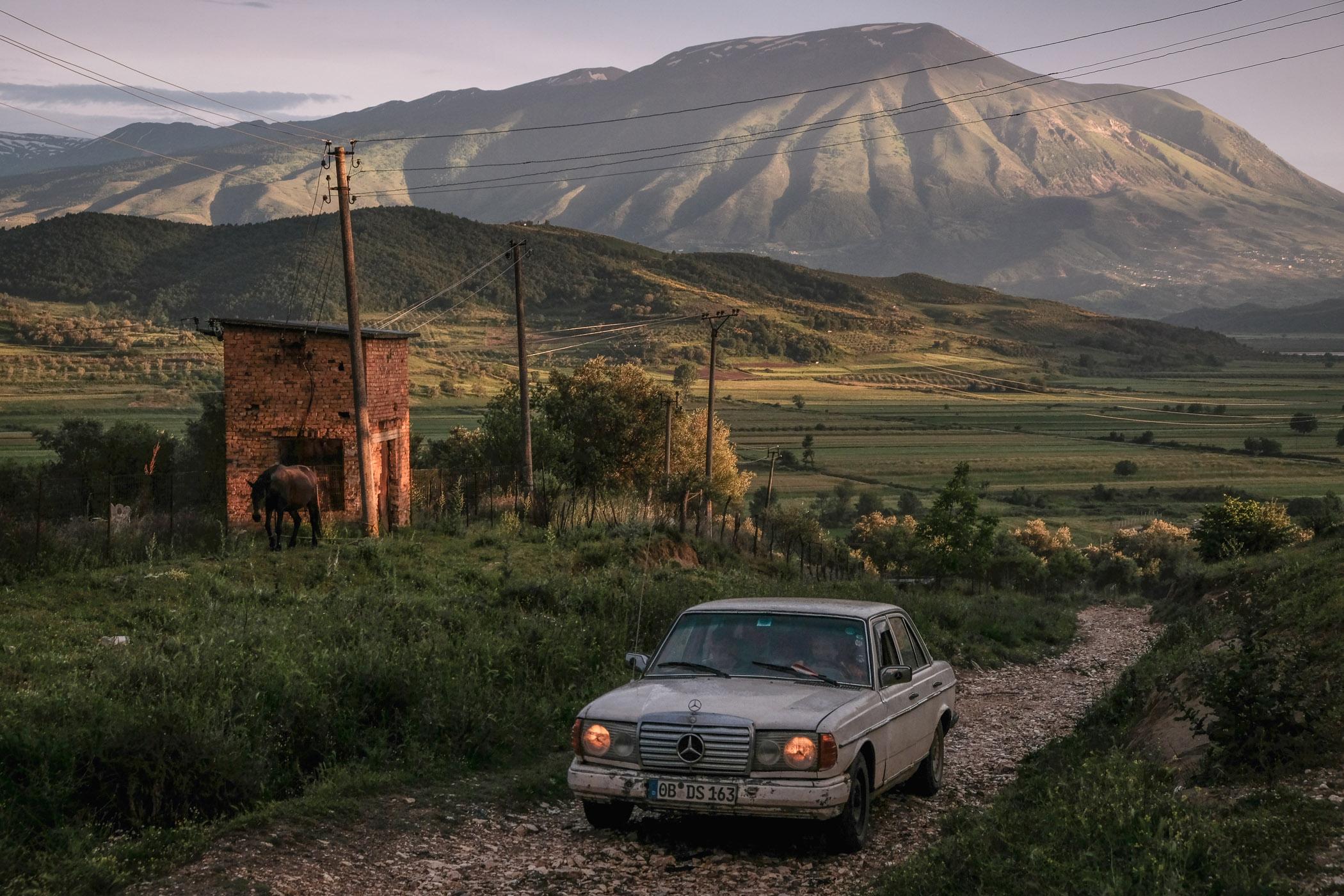A car returning from farmland near the village of Kuta in southern Albania. Located between the sites for two proposed hydropower dams, most of the agricultural land below would be flooded by a reservoir should the projects move forward.