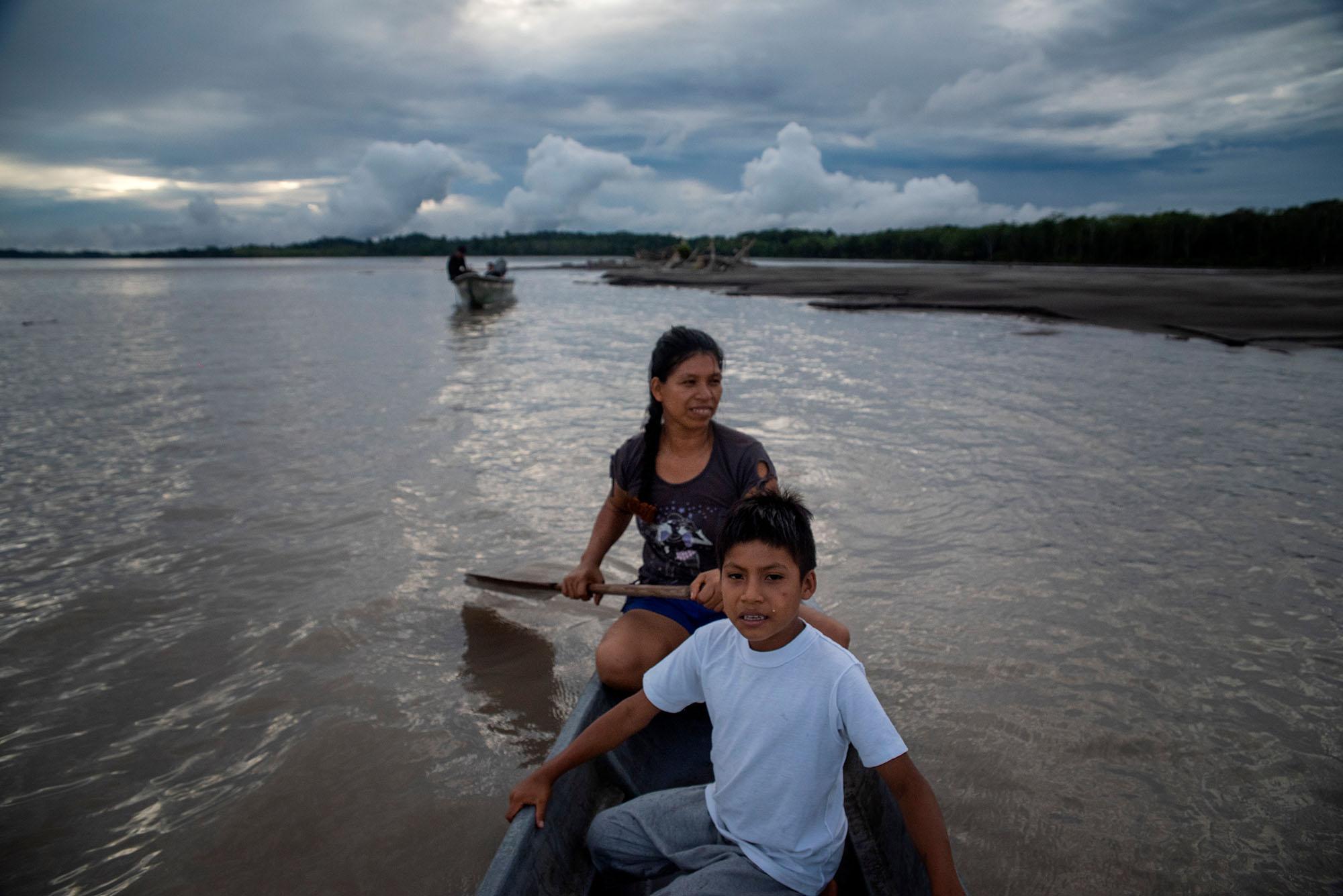 Andres Santy (9) and her mom Sany Santy (31) back to fishing dday in the Napo River on the...