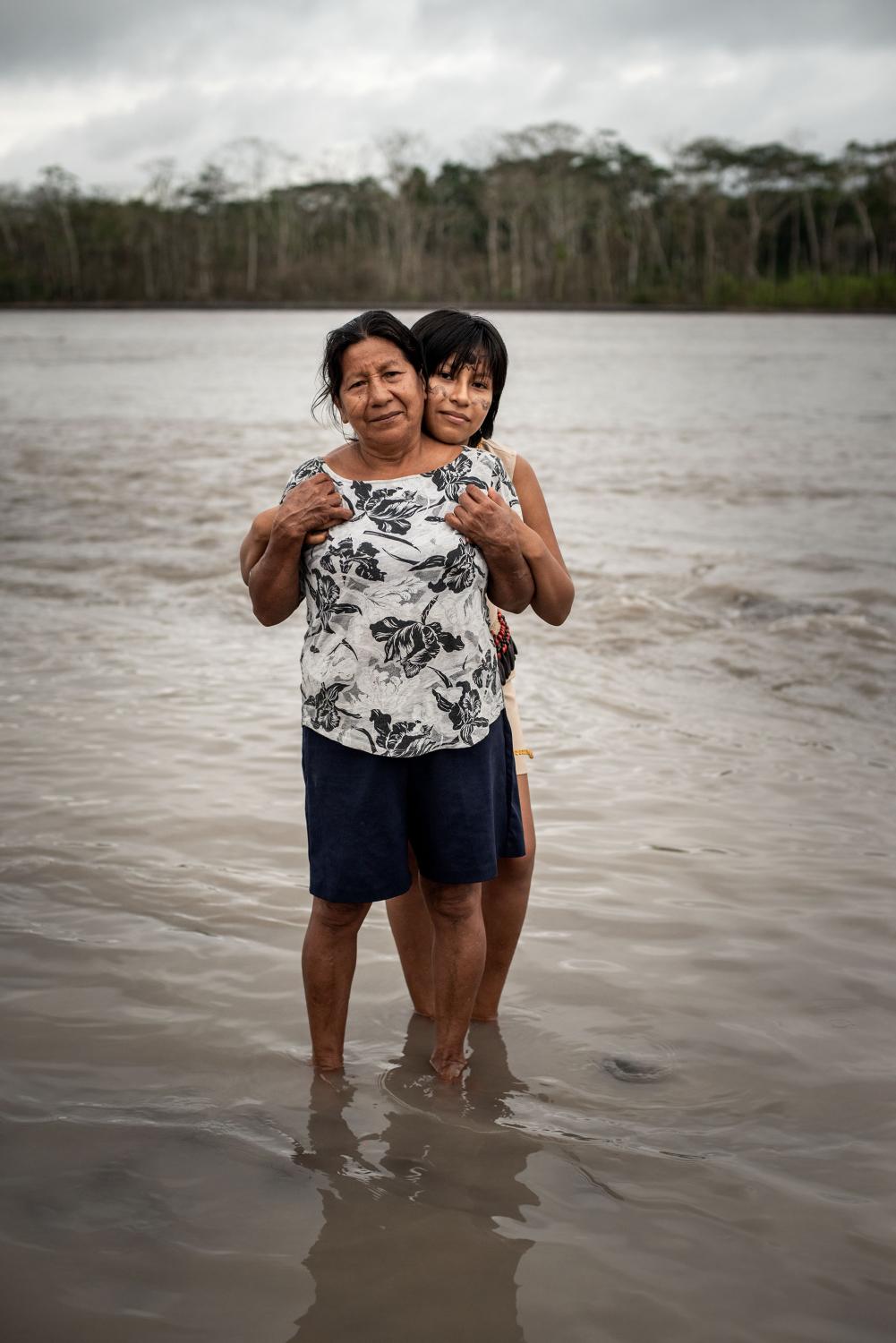 Cecilia Aguinda (62) and her daughter Sheila Grefa (17) pose for a portrait in the Napo River....