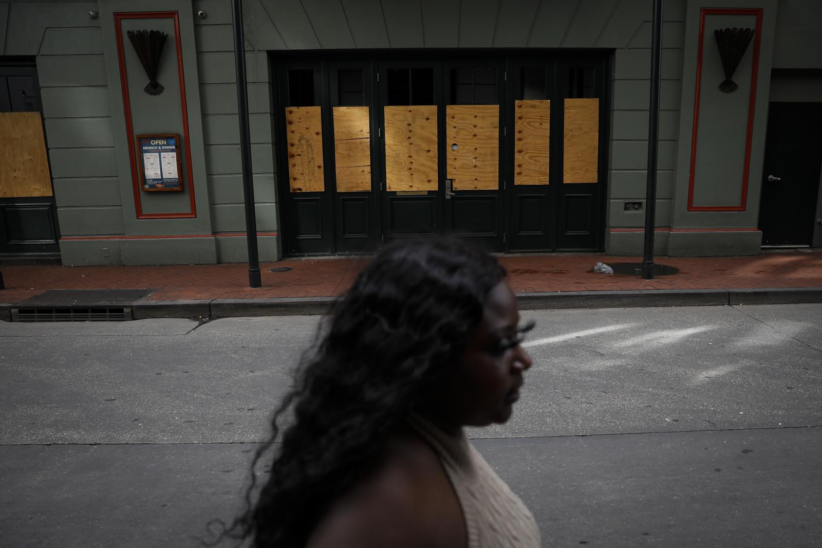 A woman walks past a restaurant...t 28, 2021. REUTERS/Marco Bello