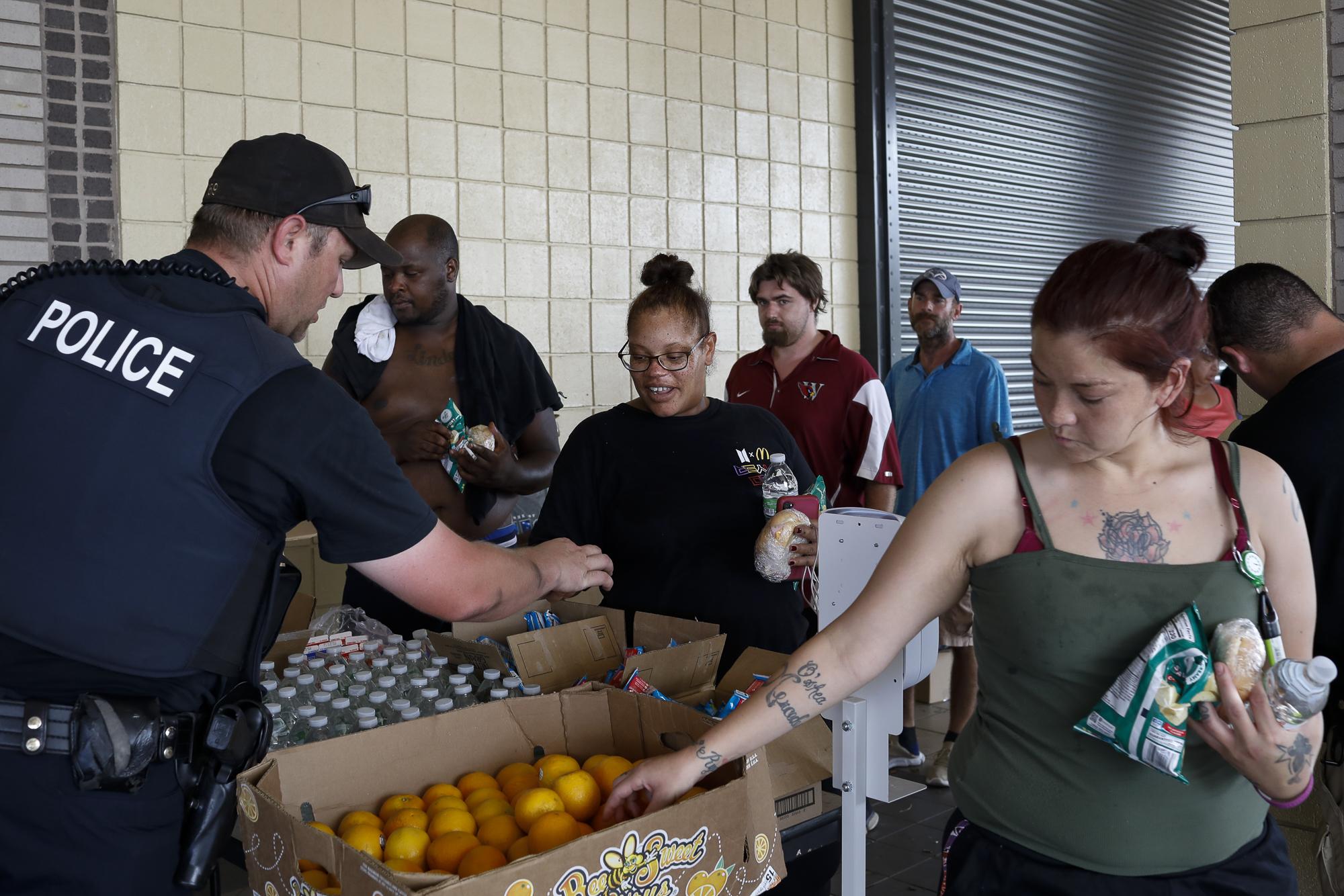 Hurricane Ida in Louisiana - People pick up snacks and water as people queue to pick...