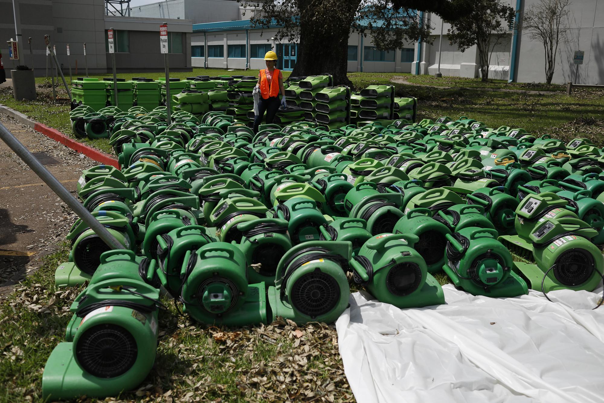 Hurricane Ida in Louisiana - A contractor stands next to air blowers to dehumidify...