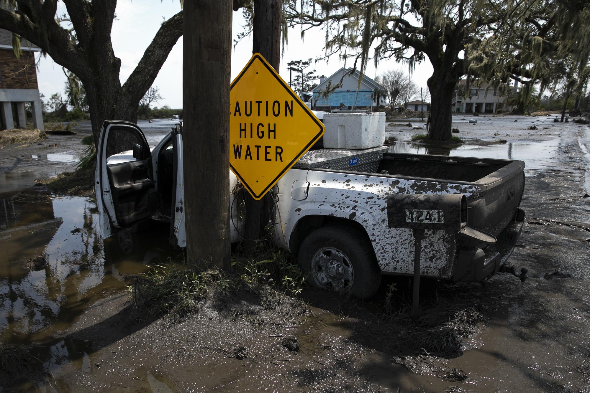 Hurricane Ida in Louisiana - A truck buried in mud is is seen in the aftermath of...