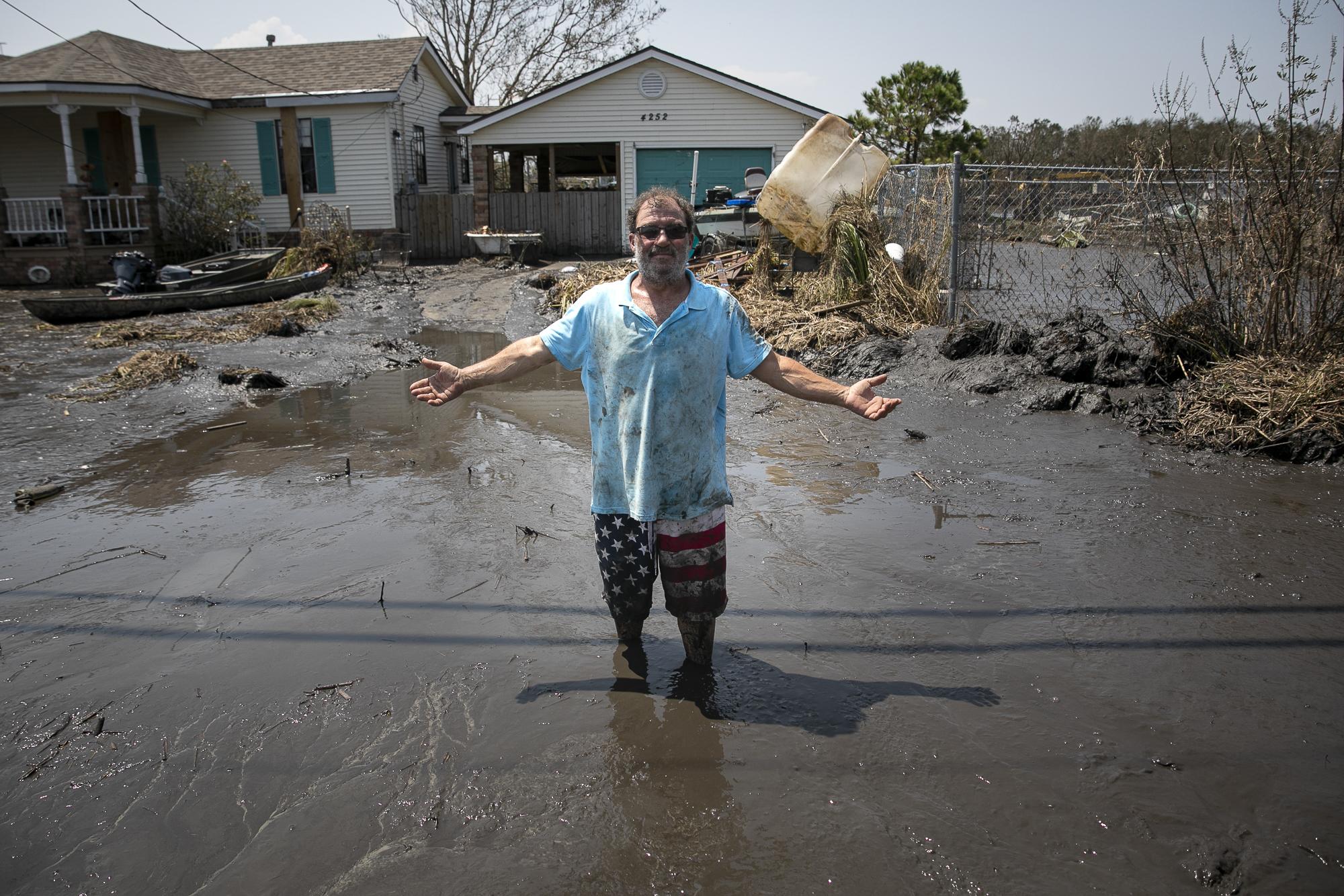 Hurricane Ida in Louisiana - Christopher Arias poses for a photo in the mud in front...