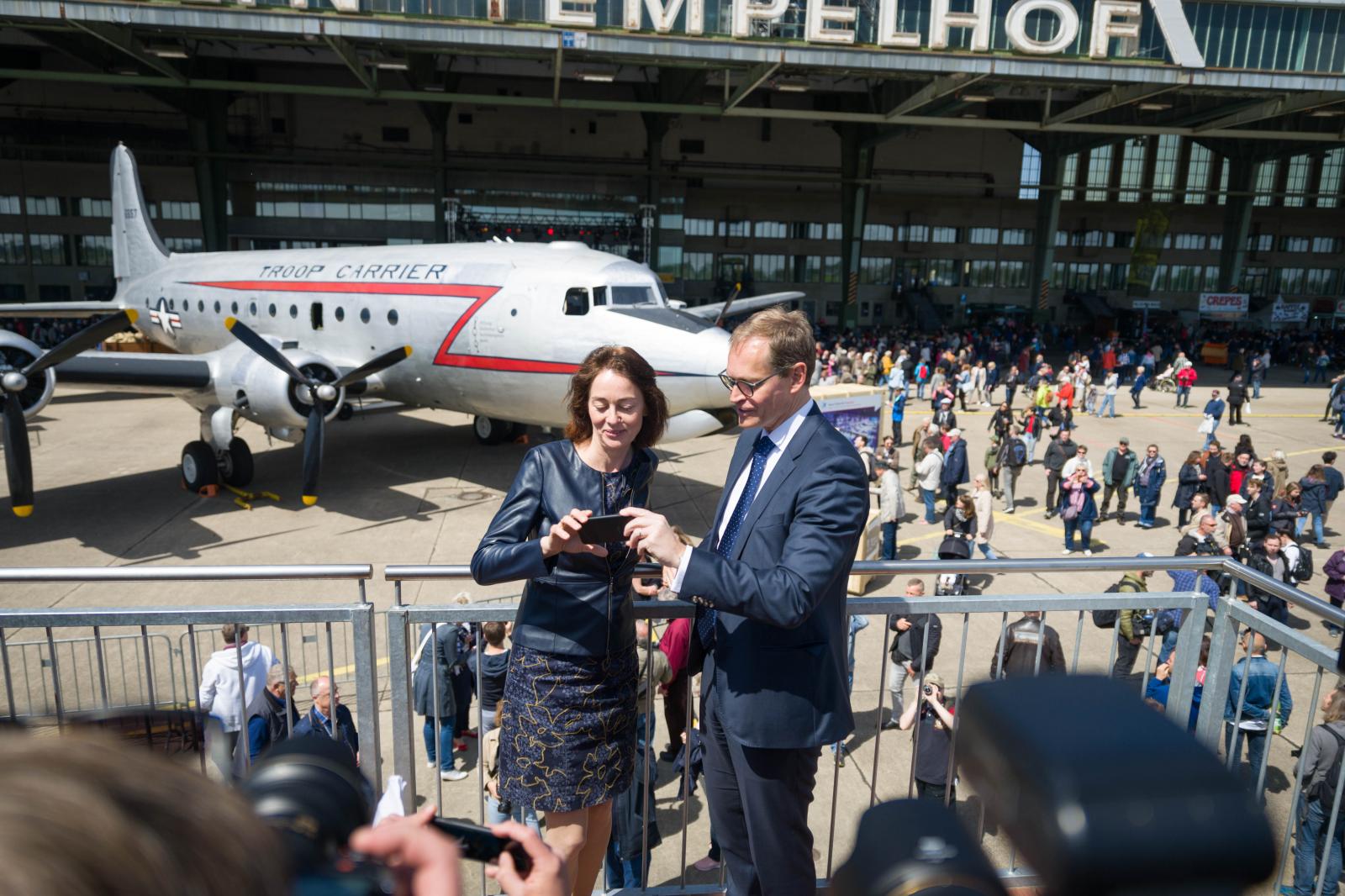 Federal Minister of Justice Katarina Barley and the Governing Mayor of Berlin Michael M&uuml;ller get ready to take a selfie in front of one of the original airplanes used by the allied forces during the Berlin blockade. May 12, 2019.