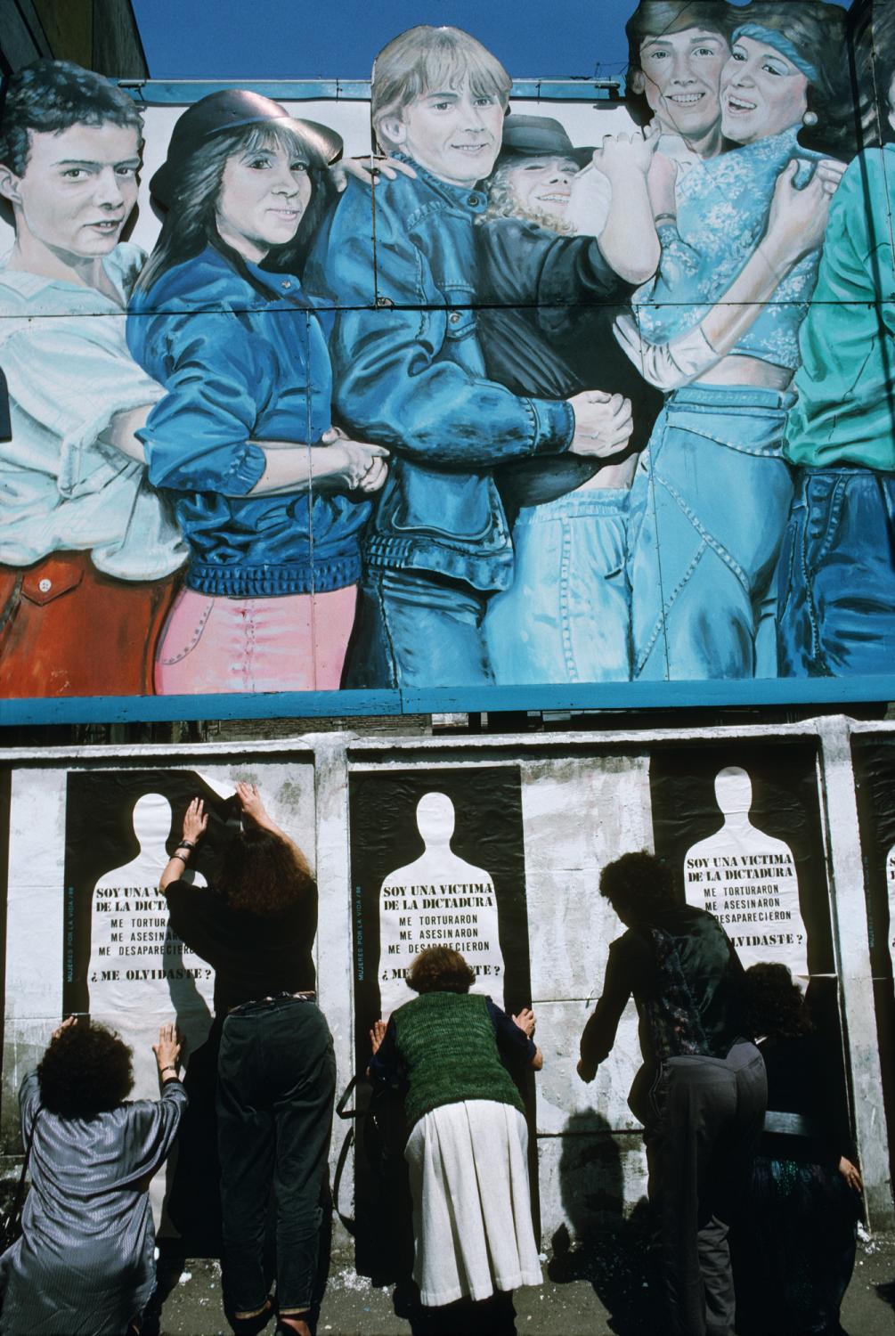 Families of &quot;desaparecidos&quot; (the disappeared) put up posters on walls in...