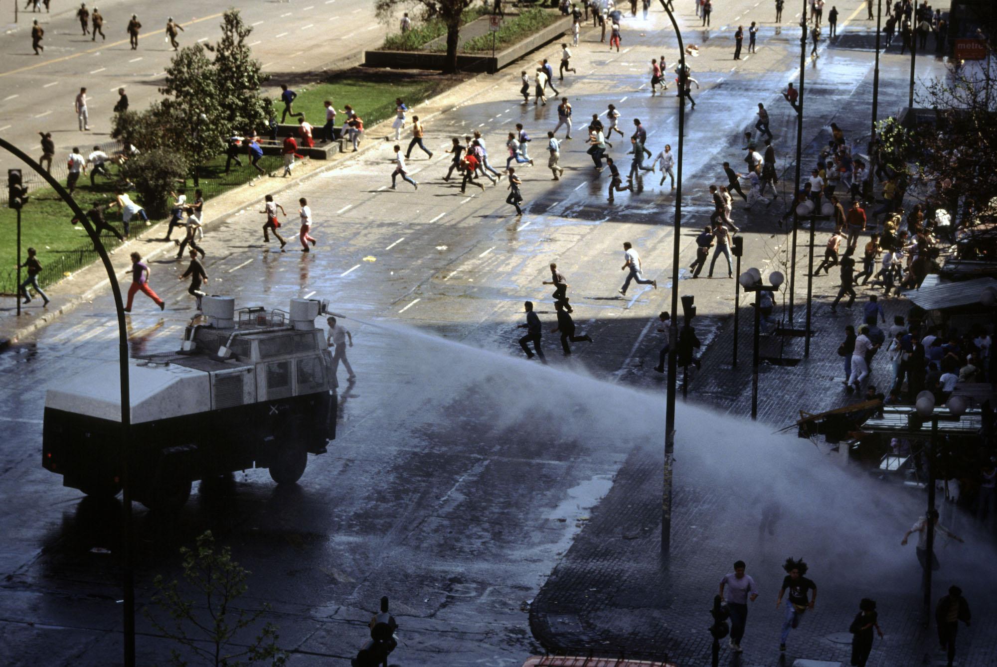 Water cannons disperse people who are celebrating victory for the &quot;No&quot;...