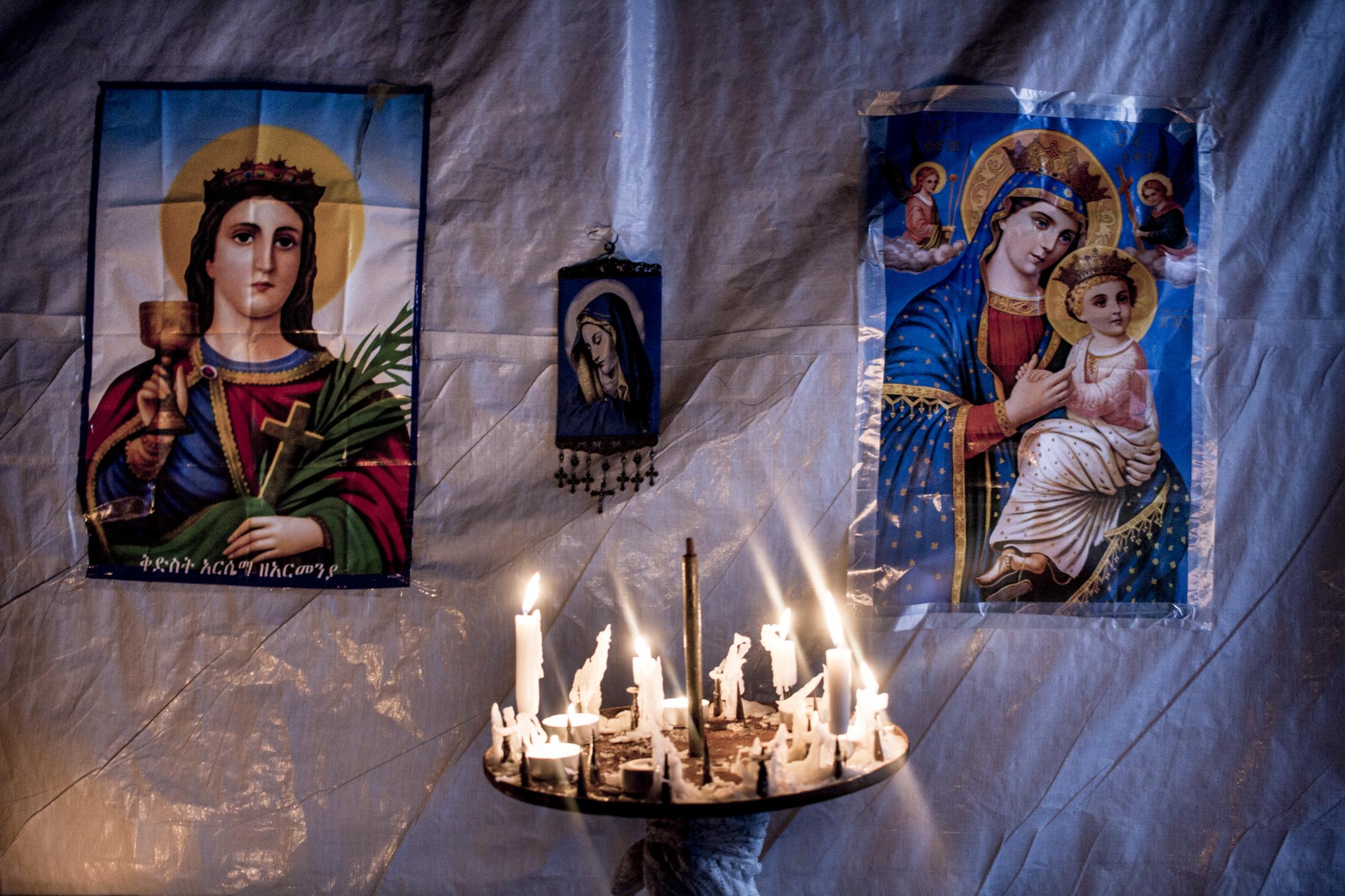 Latent urbanities - Candles inside the ethiopian orthodox church in the New Jungle, Calais&#39;refugees camp. New...