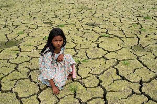 Reportage Images - A girl is seen sit on dried farmland in Narayanganj,...