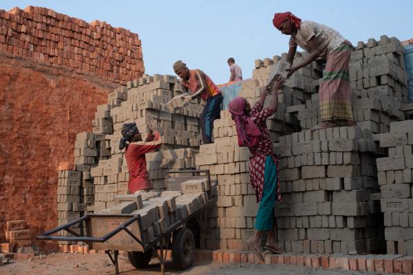 Laborers working at a brick kiln in Dhaka, Bangladesh. Low-income migrants arrive in Dhaka and work seasonally at Brickfield.