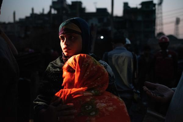 Reportage Images - Slum dwellers mourn after a massive fire broke out in...
