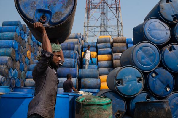 Workers stack empty drums for recycling at a warehouse in Narayanganj, Bangladesh.
