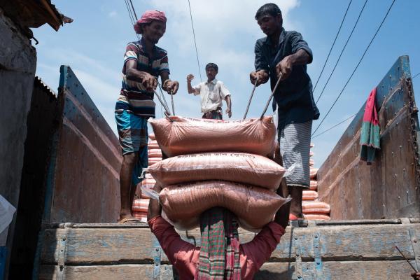 In Savar, Dhaka, Bangladesh, workers are unloading supplies from a truck near the wholesales market.