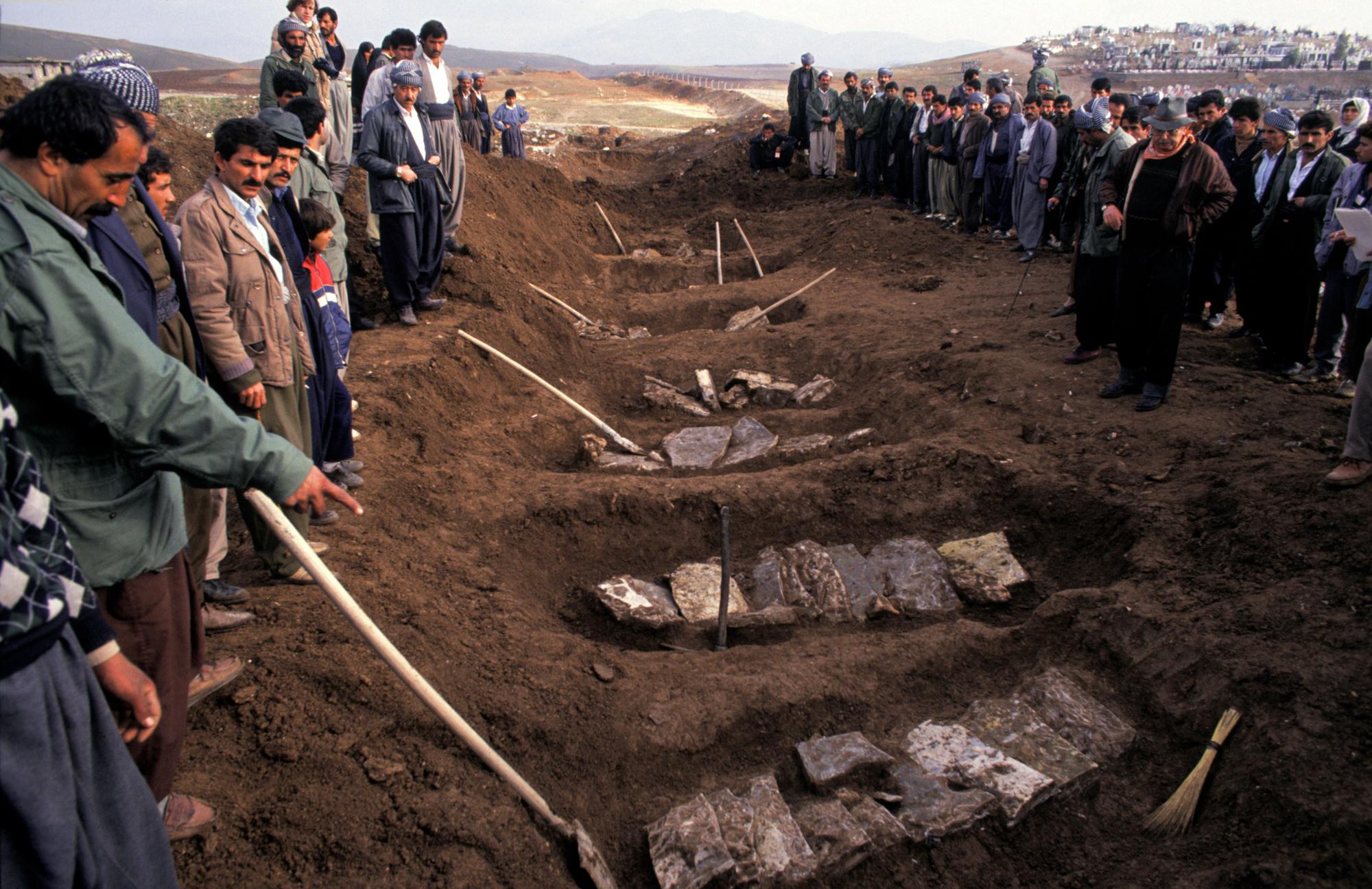 Trench graves are exhumed at the former Iraqi military headquarters of Sardaw on the outskirts of...