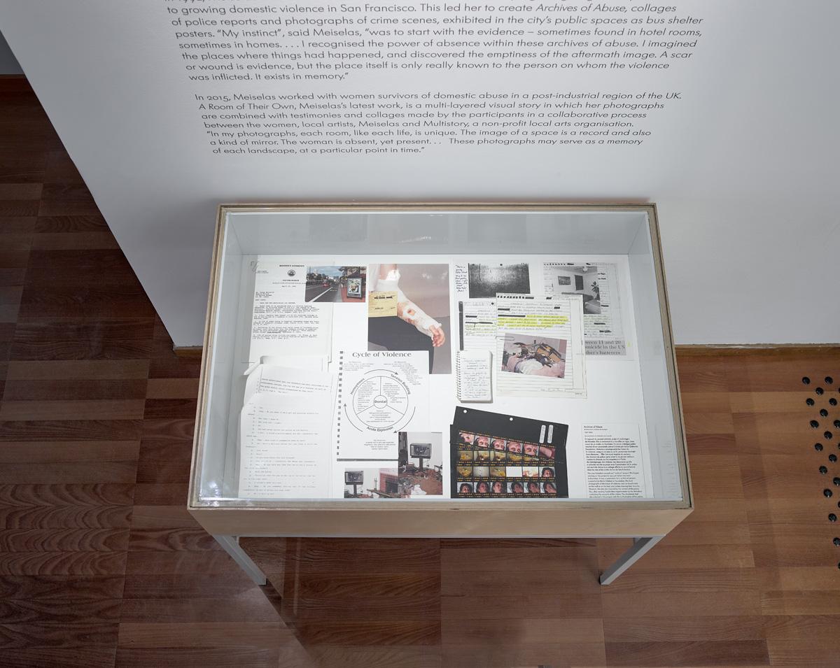 Vitrine with materials from &#39;Archives of Abuse,&#39; police reports and photos,...